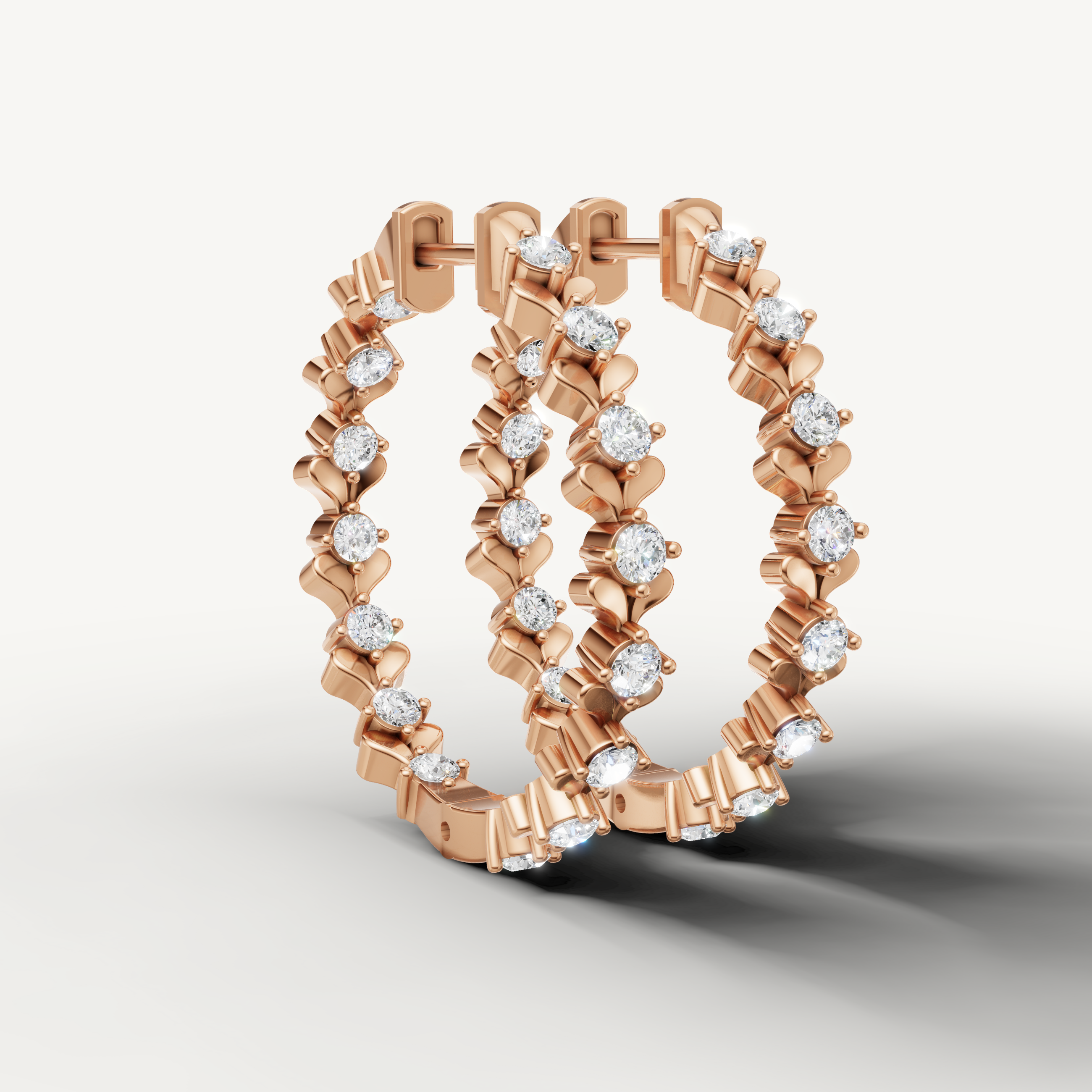 Rose gold diamond hoop earrings by Raul Diamonds with elegant floral detailing