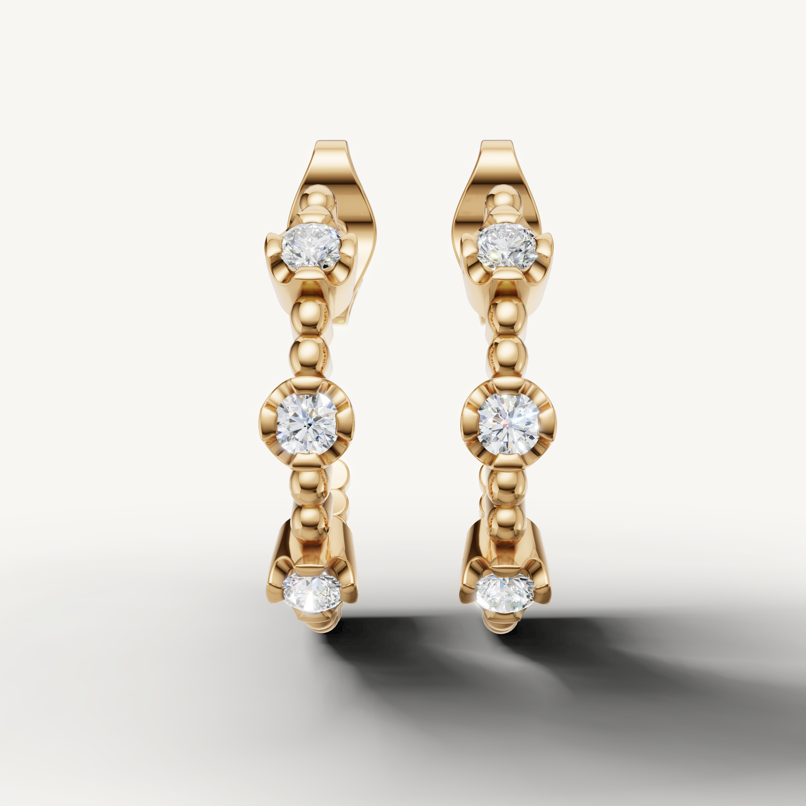 Raul Diamonds yellow gold diamond hoop earrings with round bezel set diamonds