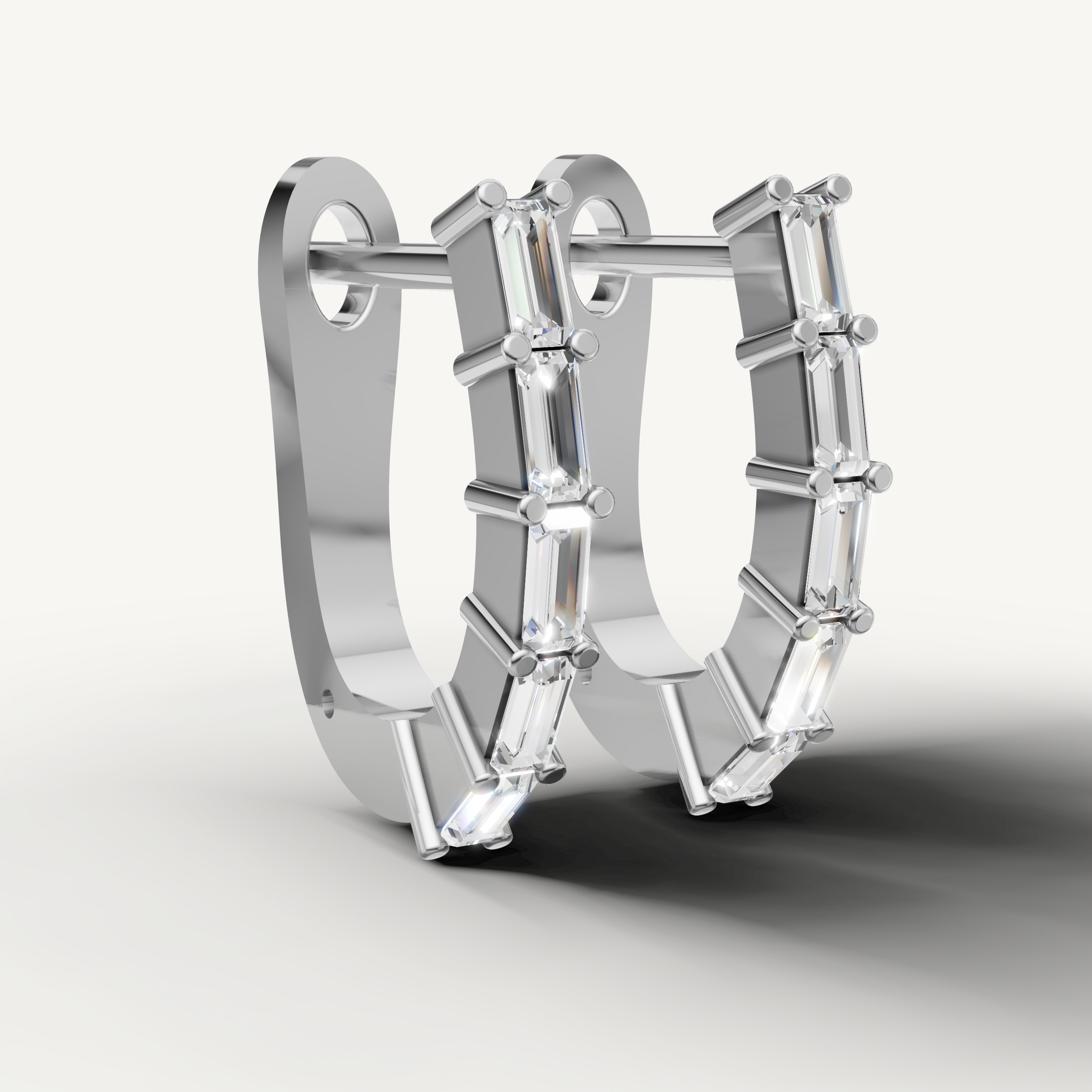 Elegant white gold hoop earrings featuring sparkling baguette diamonds
