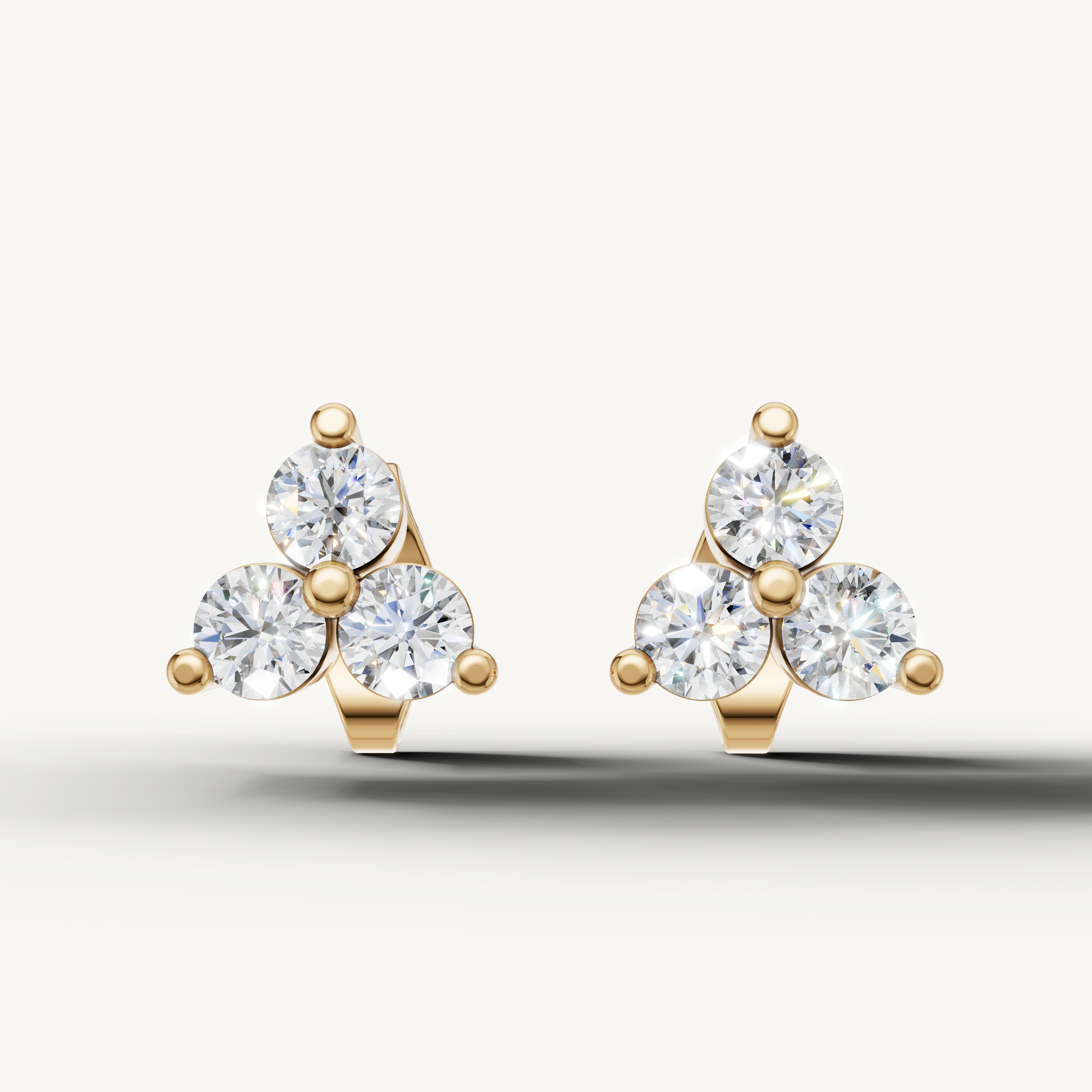 Raul Diamonds yellow gold three stone diamond stud earrings for women