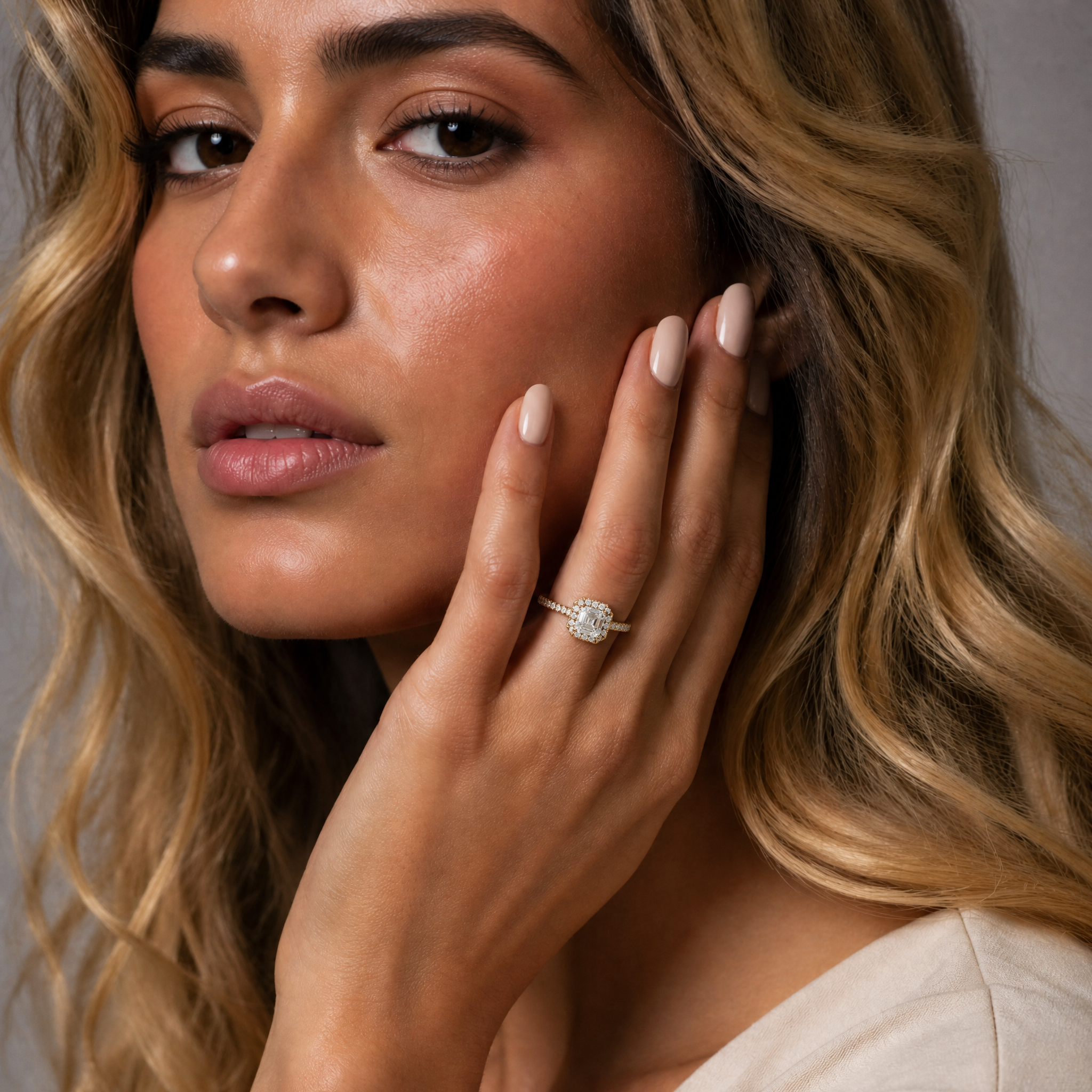Elena V. elegantly showcasing a Raul Diamonds Asscher cut halo engagement ring with a pave diamond band.