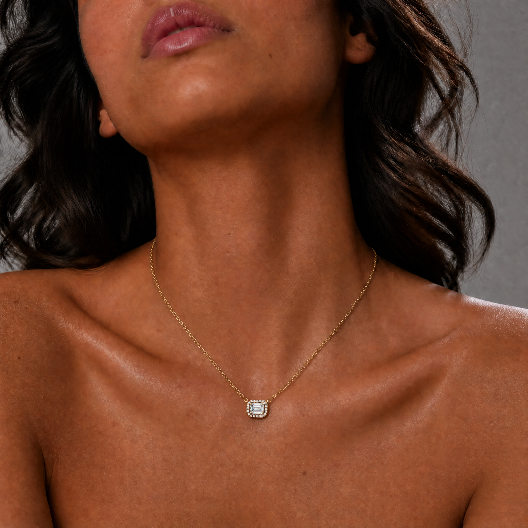 Female Model Wearing East West Emerald Cut Lab Grown Diamond Halo Pendant Necklace in 14K Gold by Raul Diamonds