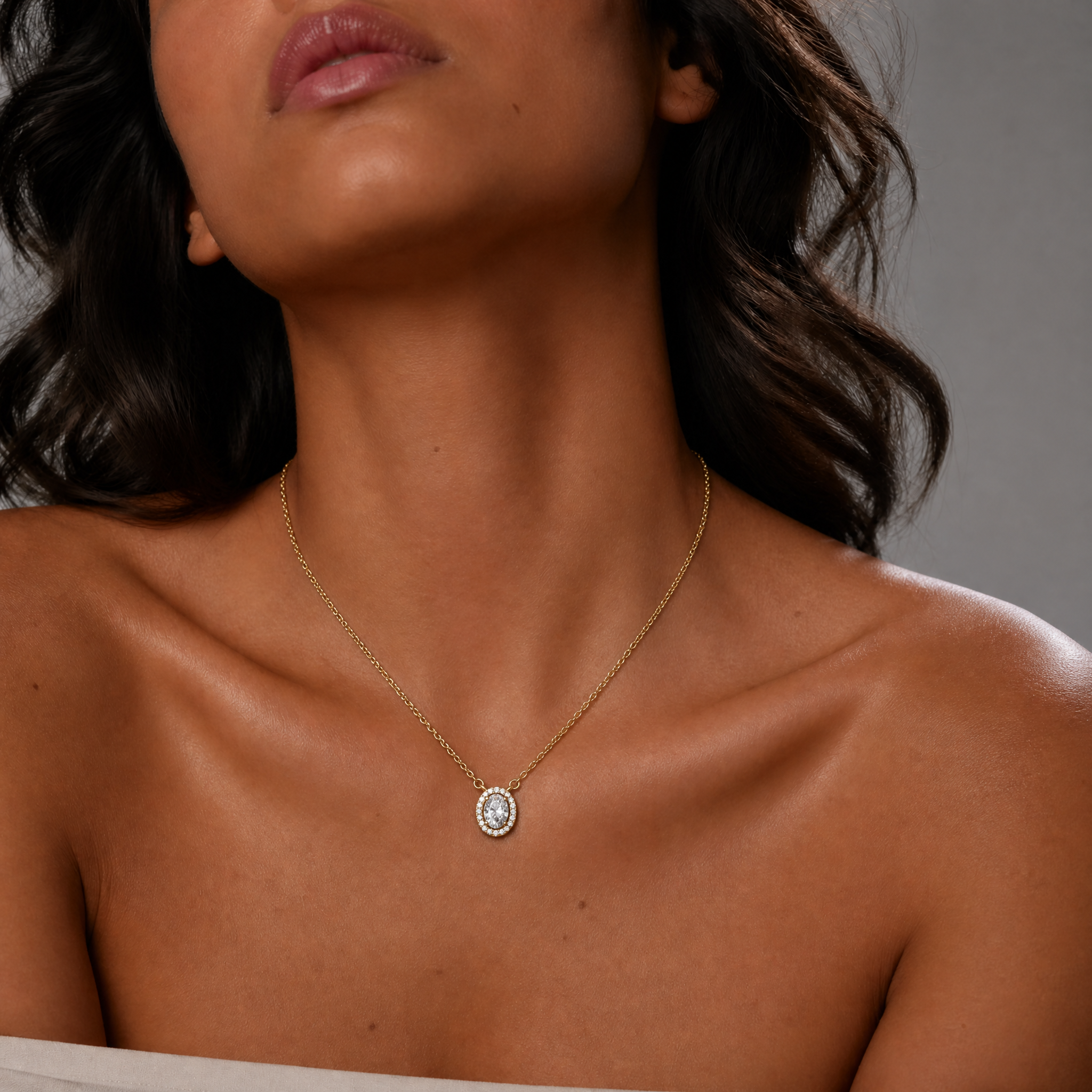 Female Model Wearing Oval Lab Grown Diamond Halo Pendant Necklace in 14K Gold by Raul Diamonds