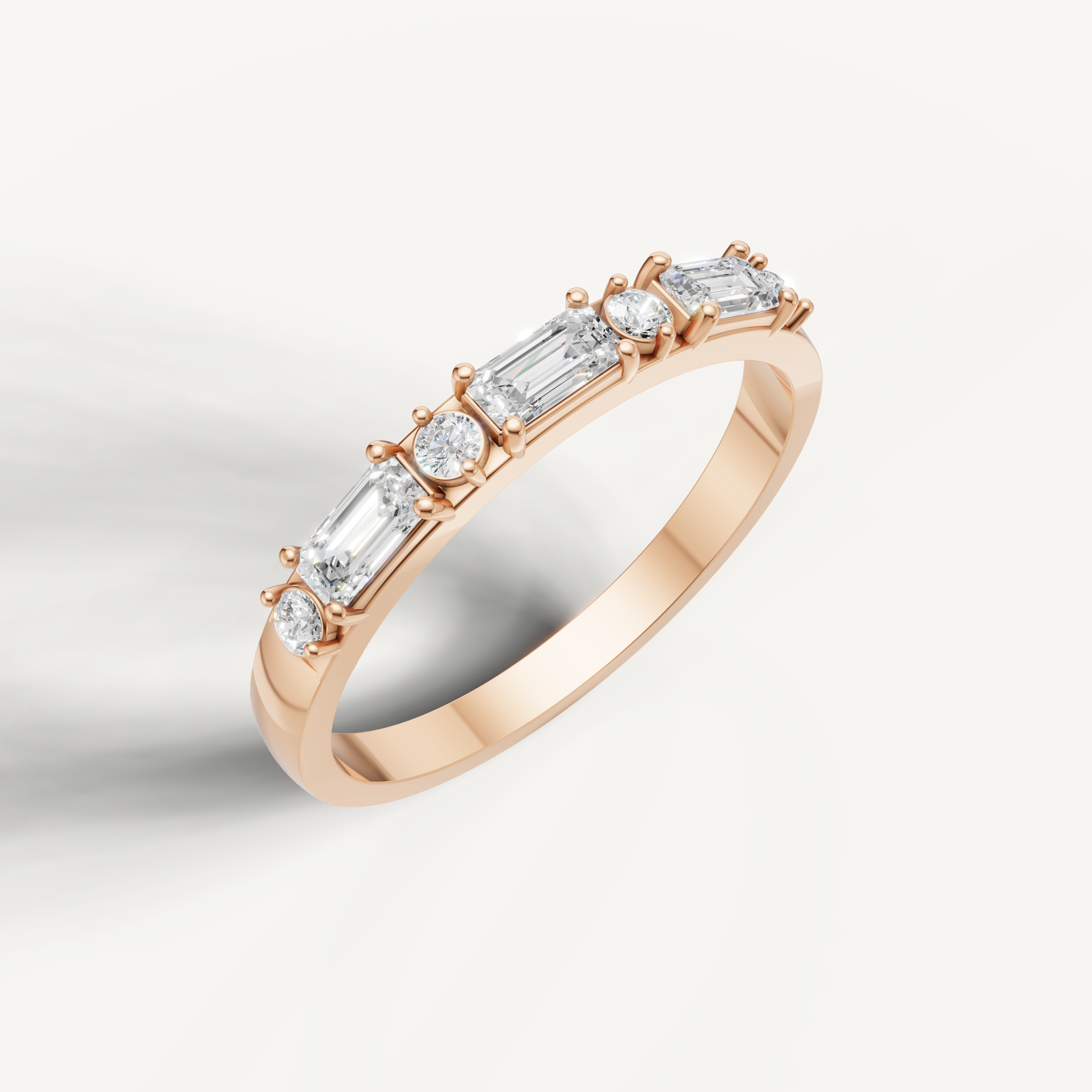 Rose gold diamond wedding ring featuring emerald and round cut diamonds in shared prong style