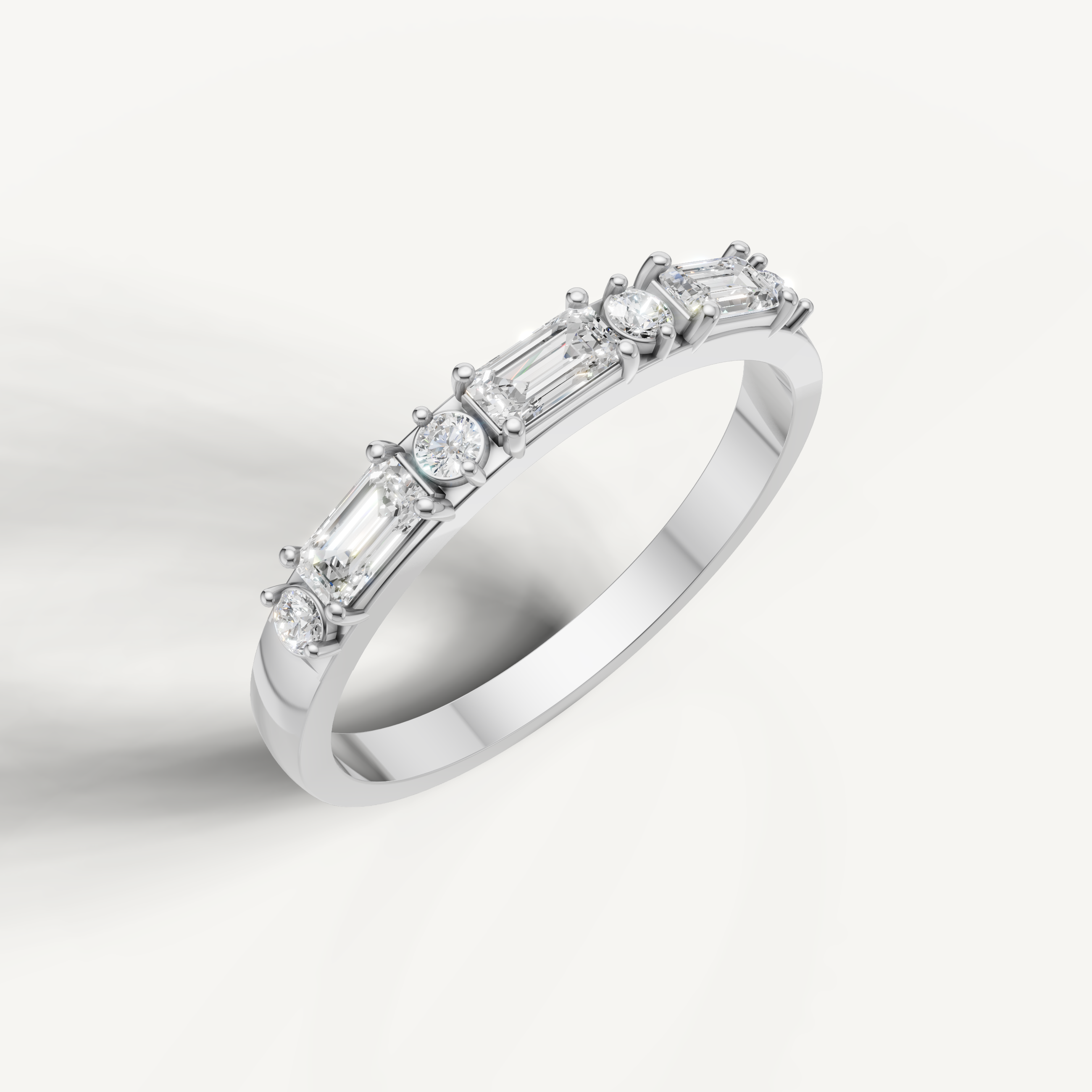White gold diamond anniversary ring featuring emerald cut and round brilliant diamonds
