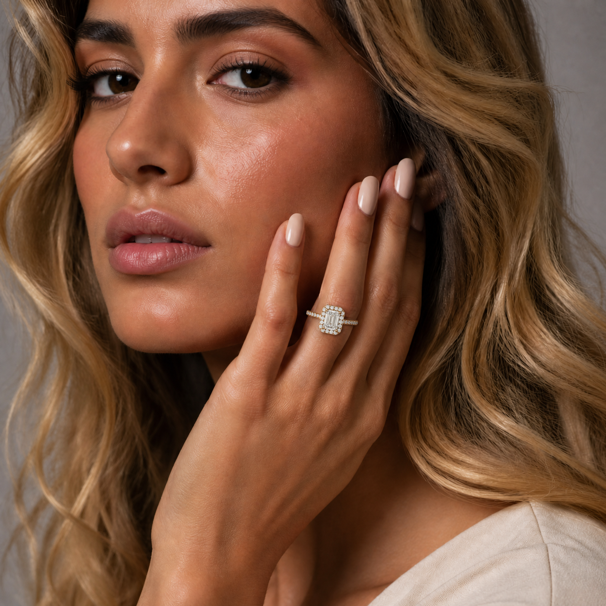 Isabella Moreno showcasing the refined elegance of a Raul Diamonds emerald cut halo engagement ring, emphasizing the luxurious craftsmanship and diamond brilliance