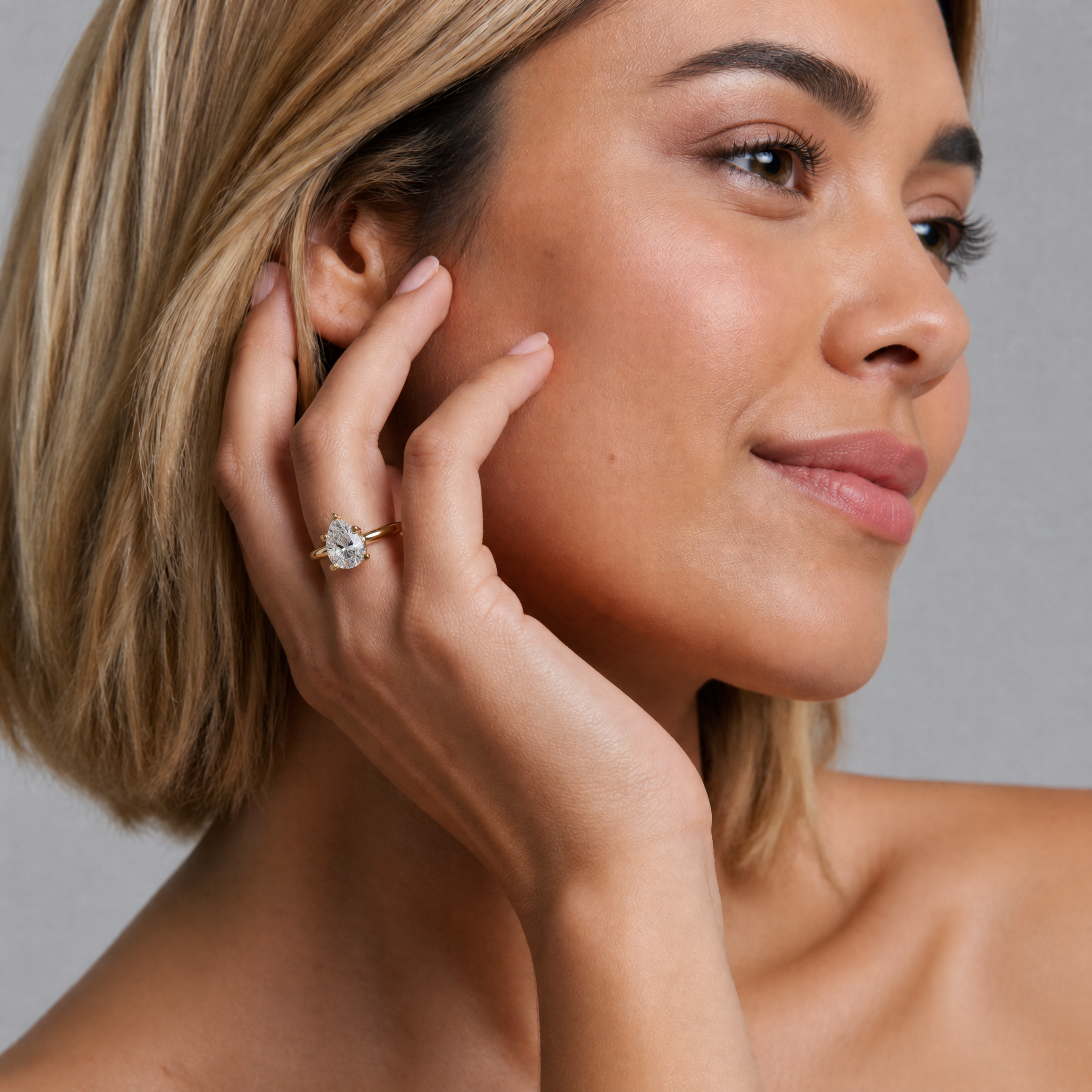 High-jewelry model Isabella Valli for Raul Diamonds, showcasing a brilliant pear-cut engagement ring that creates an elegant, elongated look on the hand.