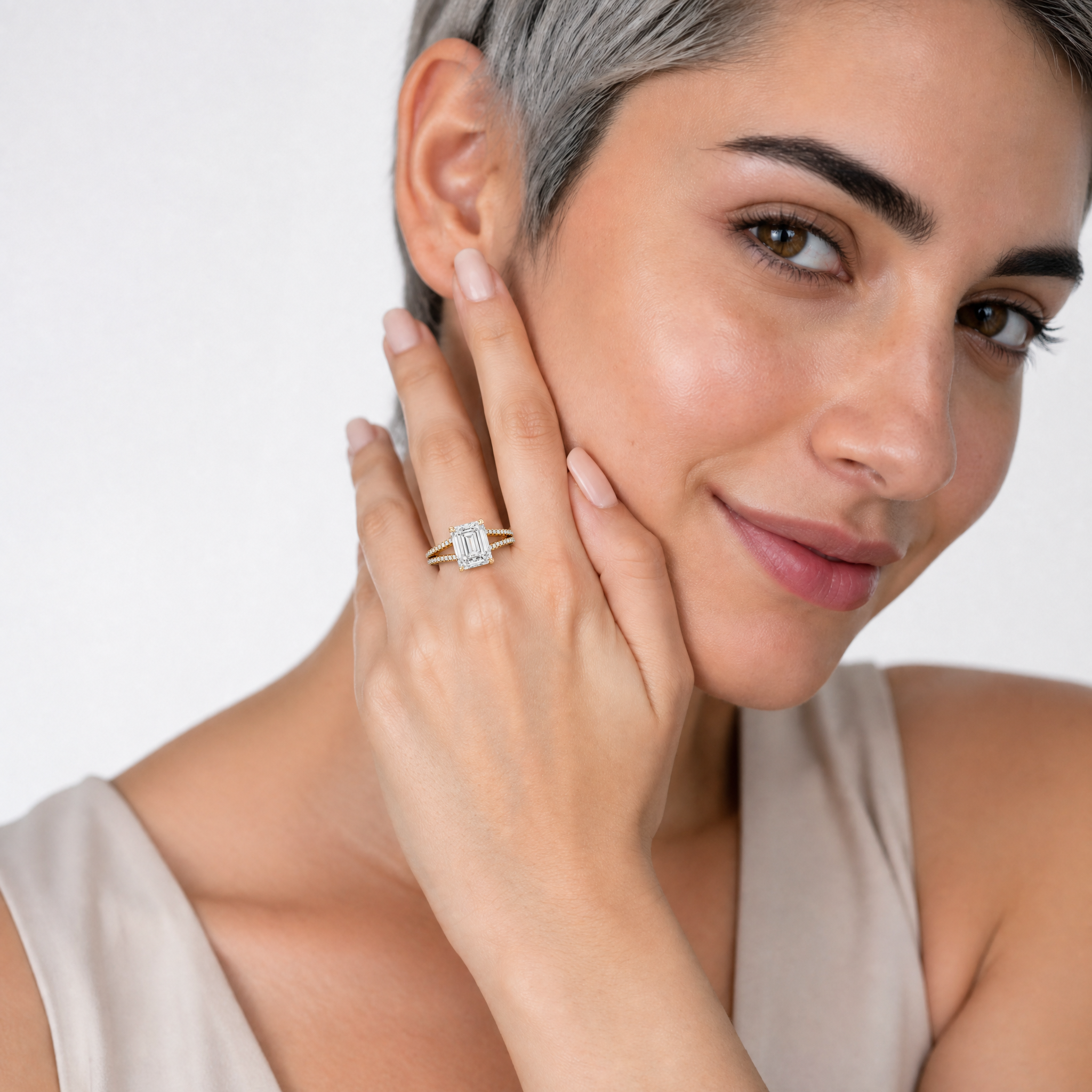 Woman Wearing Emerald Cut Lab Grown Diamond Engagement Ring in 14K Yellow Gold – Raul Diamonds