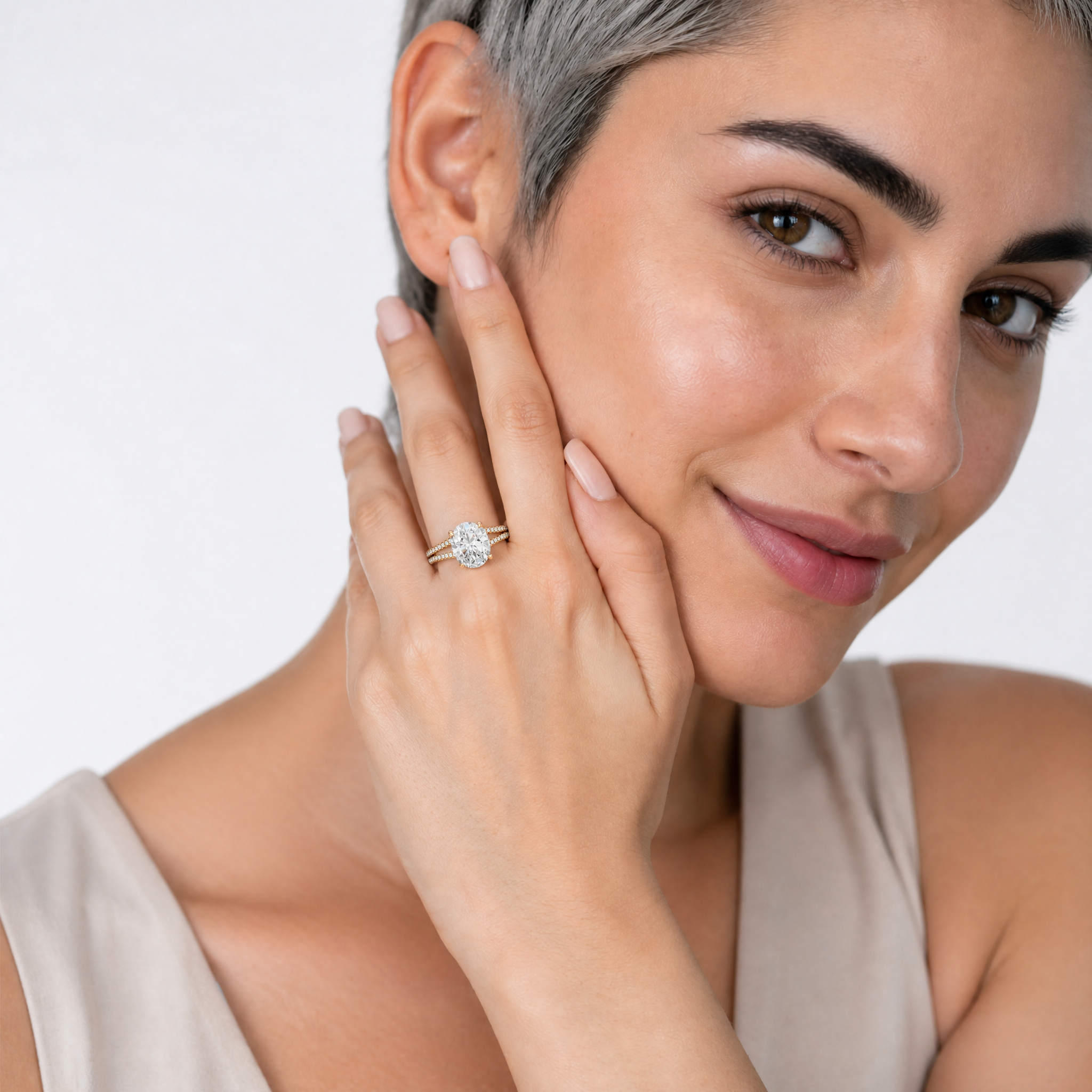 Woman Wearing Oval Cut Lab Grown Diamond Engagement Ring in 14K Yellow Gold – Raul Diamonds