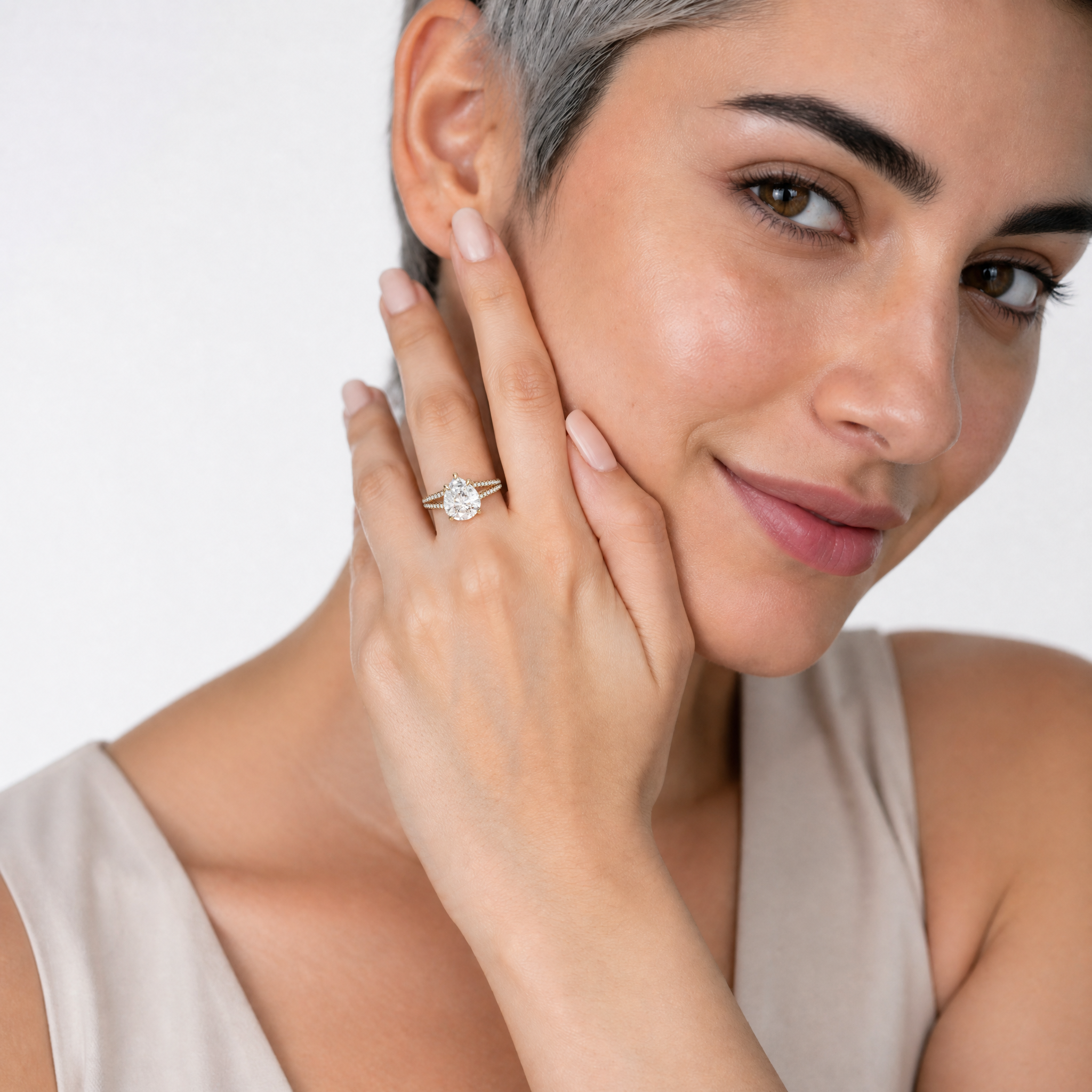 Woman Wearing Pear Cut Lab Grown Diamond Engagement Ring in 14K Yellow Gold – Raul Diamonds