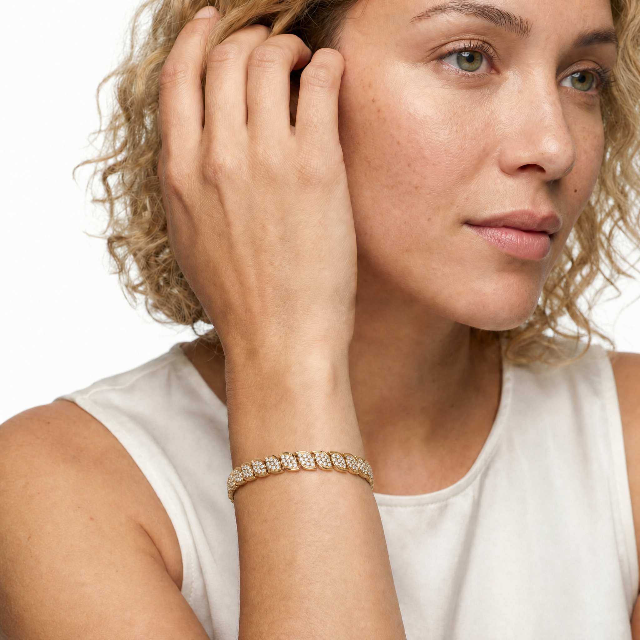 Luxury female model wearing a yellow gold leaf-inspired lab grown diamond bracelet by Raul Diamonds featuring marquise floral motifs and elegant fine jewelry styling