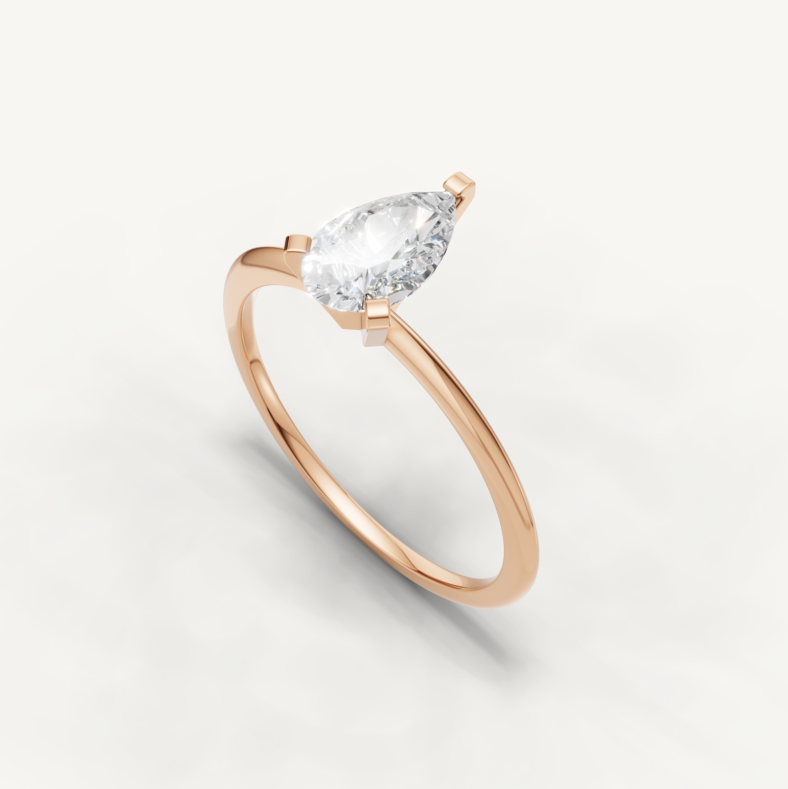 Thin band pear cut solitaire ring in rose gold by Raul Diamonds
