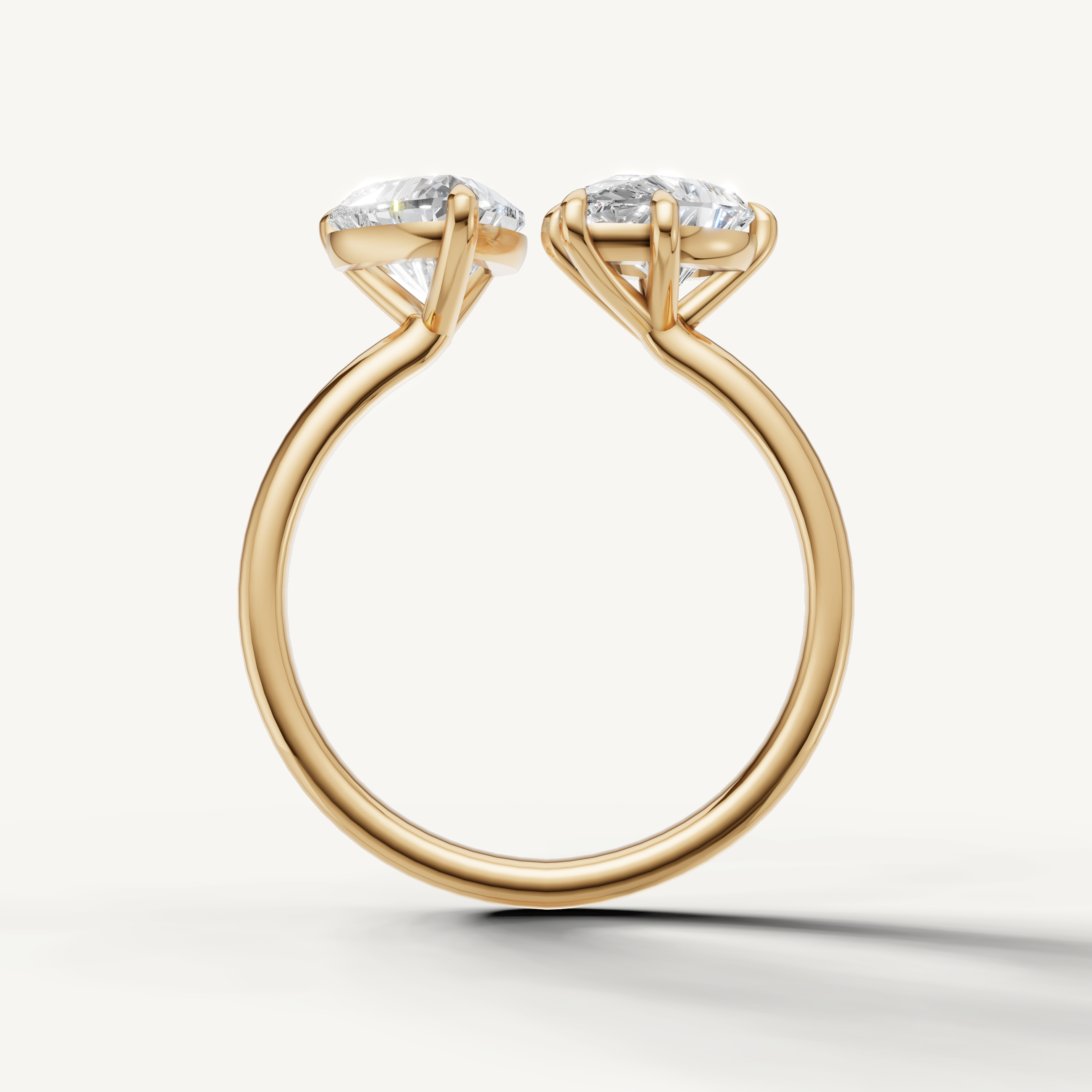Modern yellow gold toi et moi diamond ring with brilliant pear and emerald cuts from Raul Diamonds