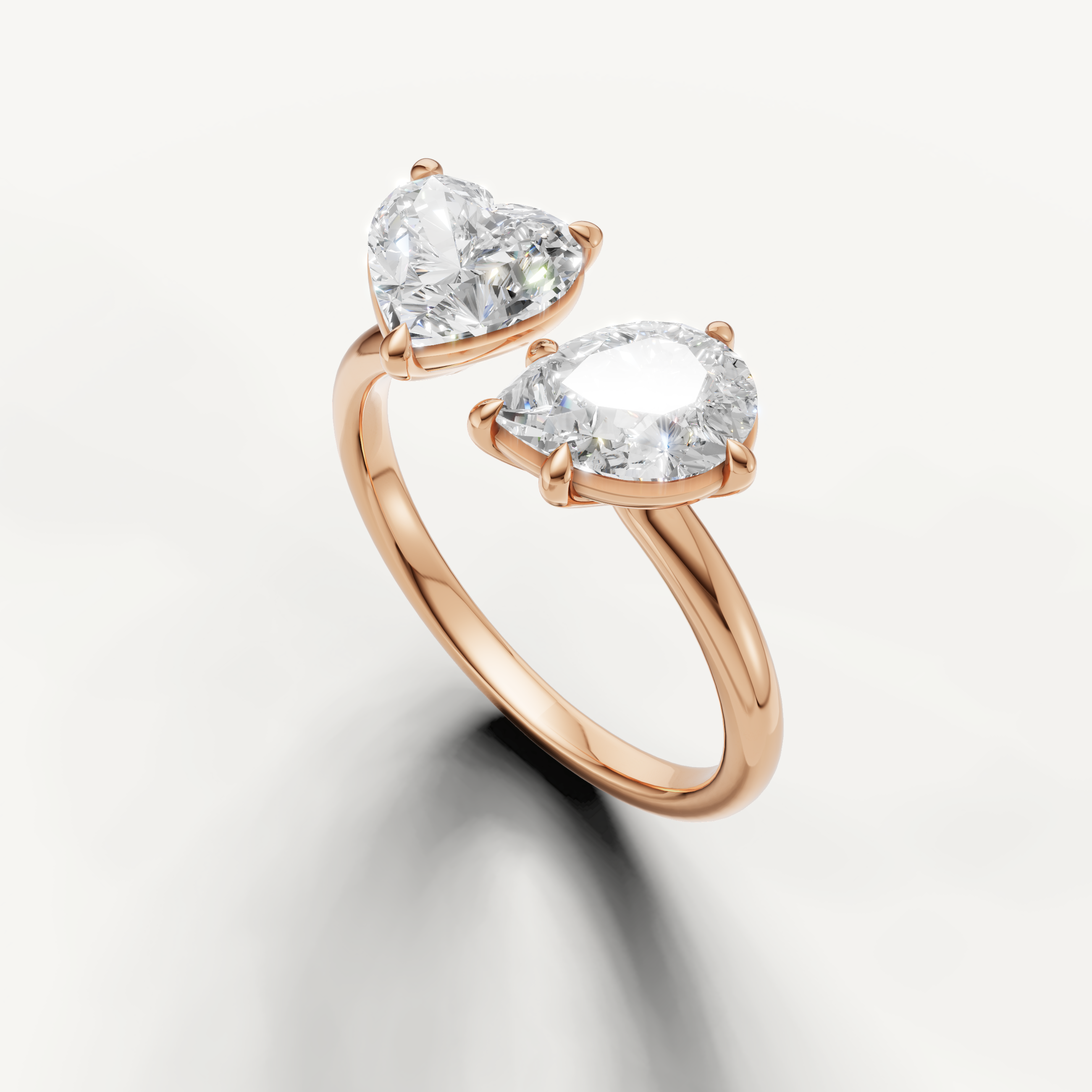 Luxury rose gold pear and emerald cut engagement ring crafted by Raul Diamonds