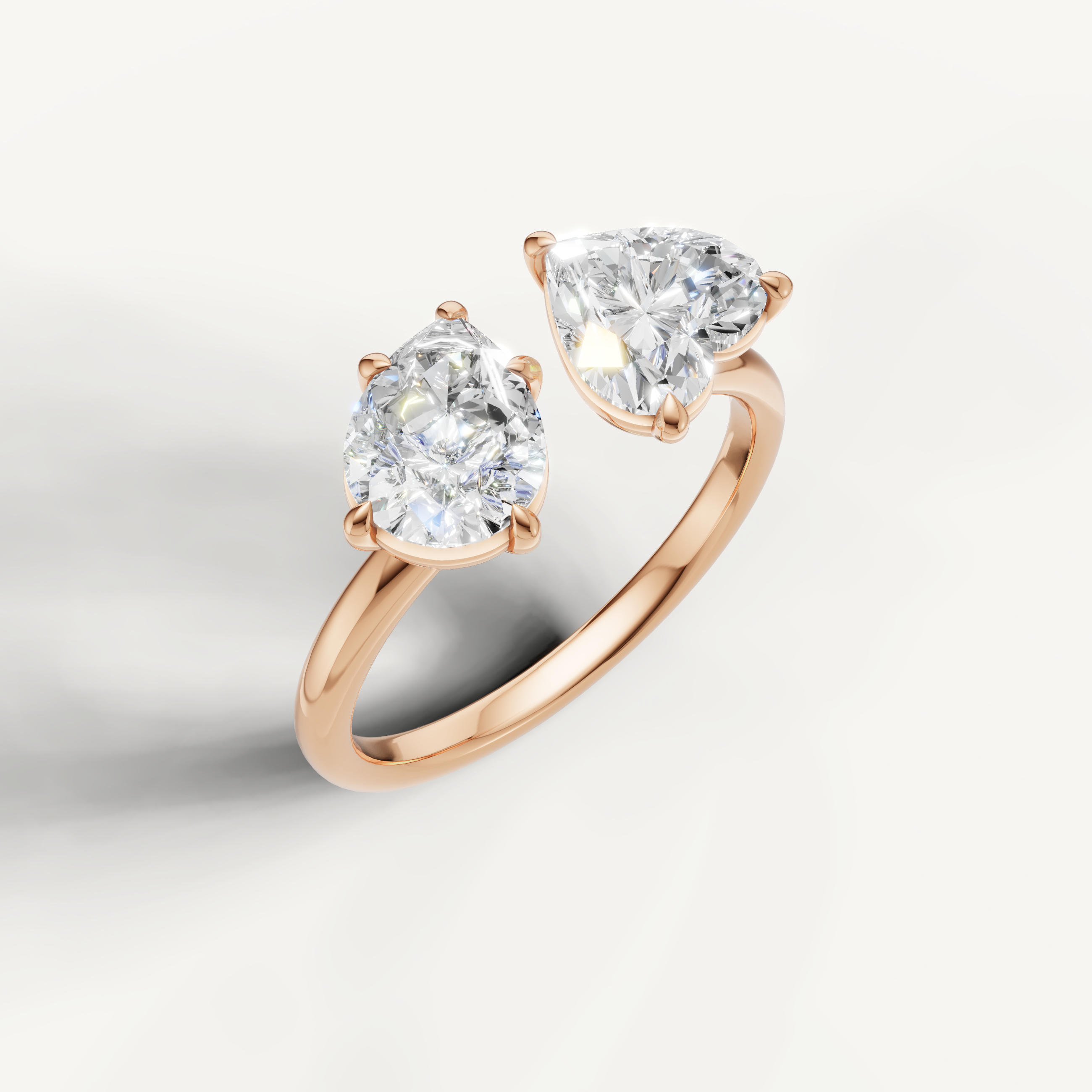 Romantic rose gold dual stone diamond ring by Raul Diamonds with pear and emerald solitaire design