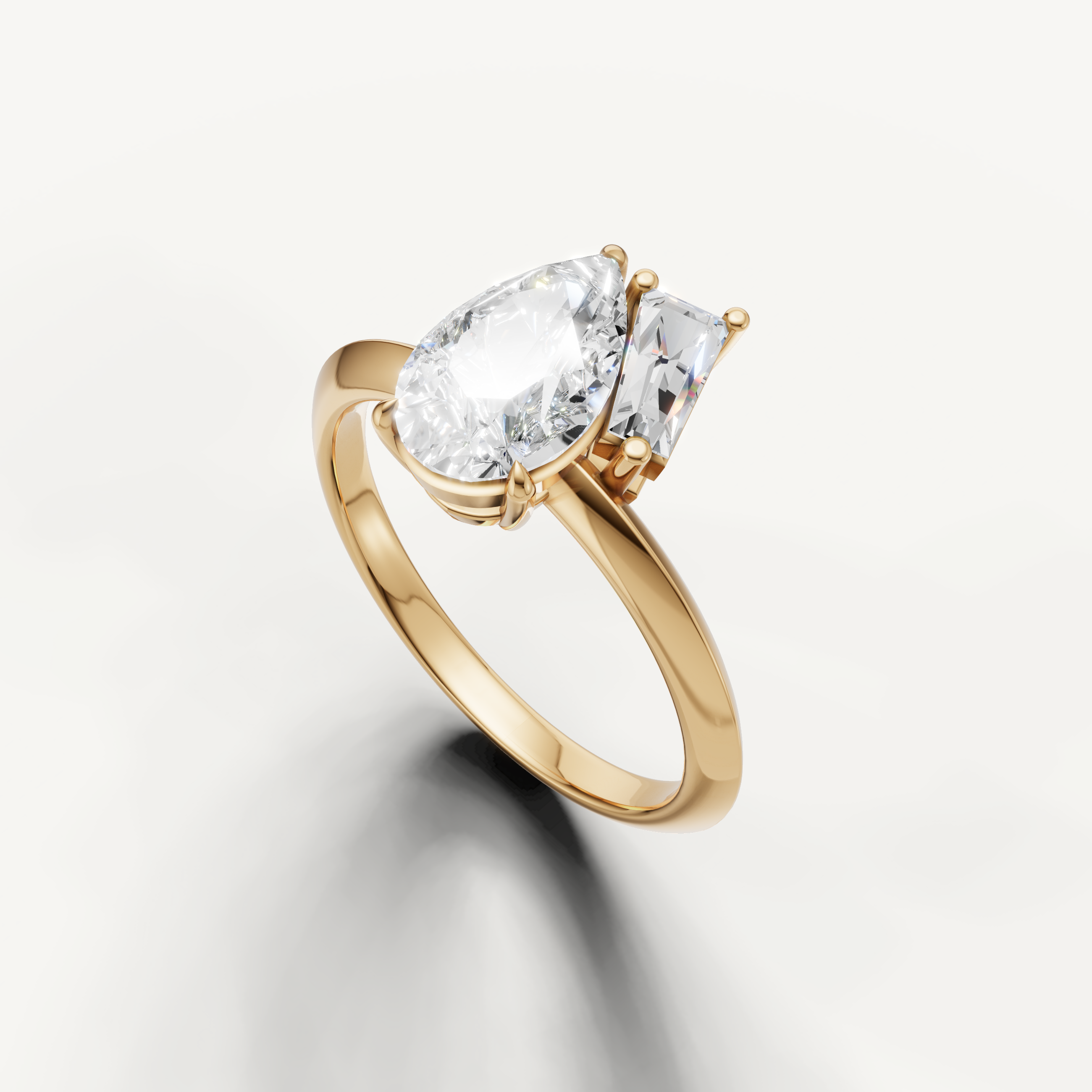 Luxury yellow gold dual stone diamond engagement ring with pear and trapezoid cuts from Raul Diamonds