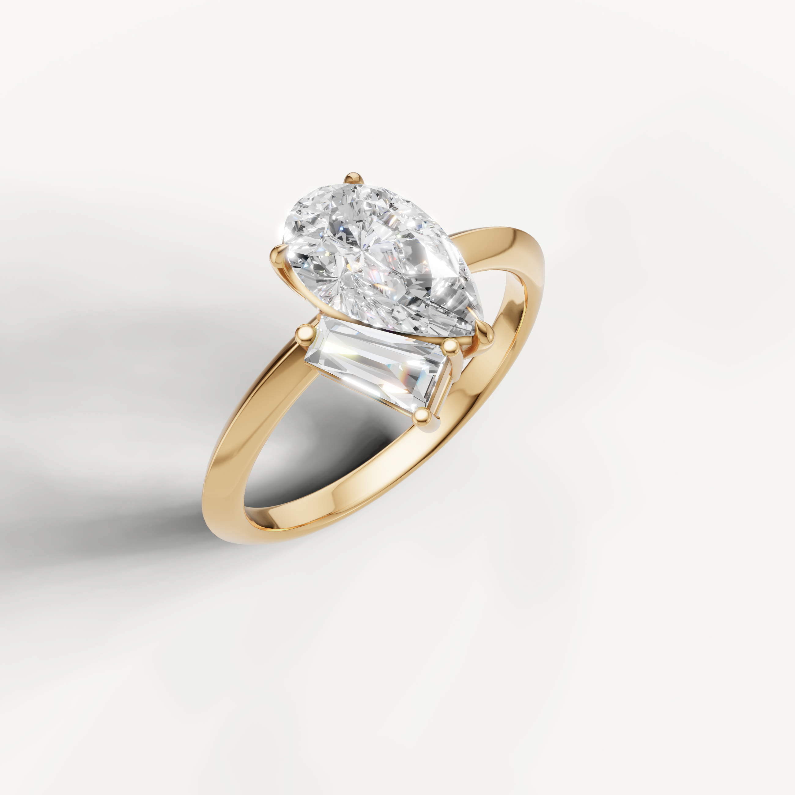 Elegant yellow gold pear and trapezoid diamond ring by Raul Diamonds for modern brides