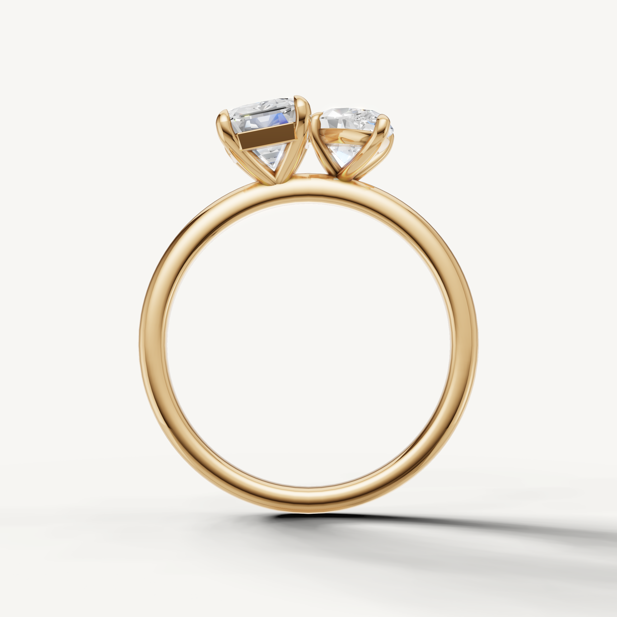 Contemporary yellow gold toi et moi ring featuring marquise and emerald cut diamonds by Raul Diamonds