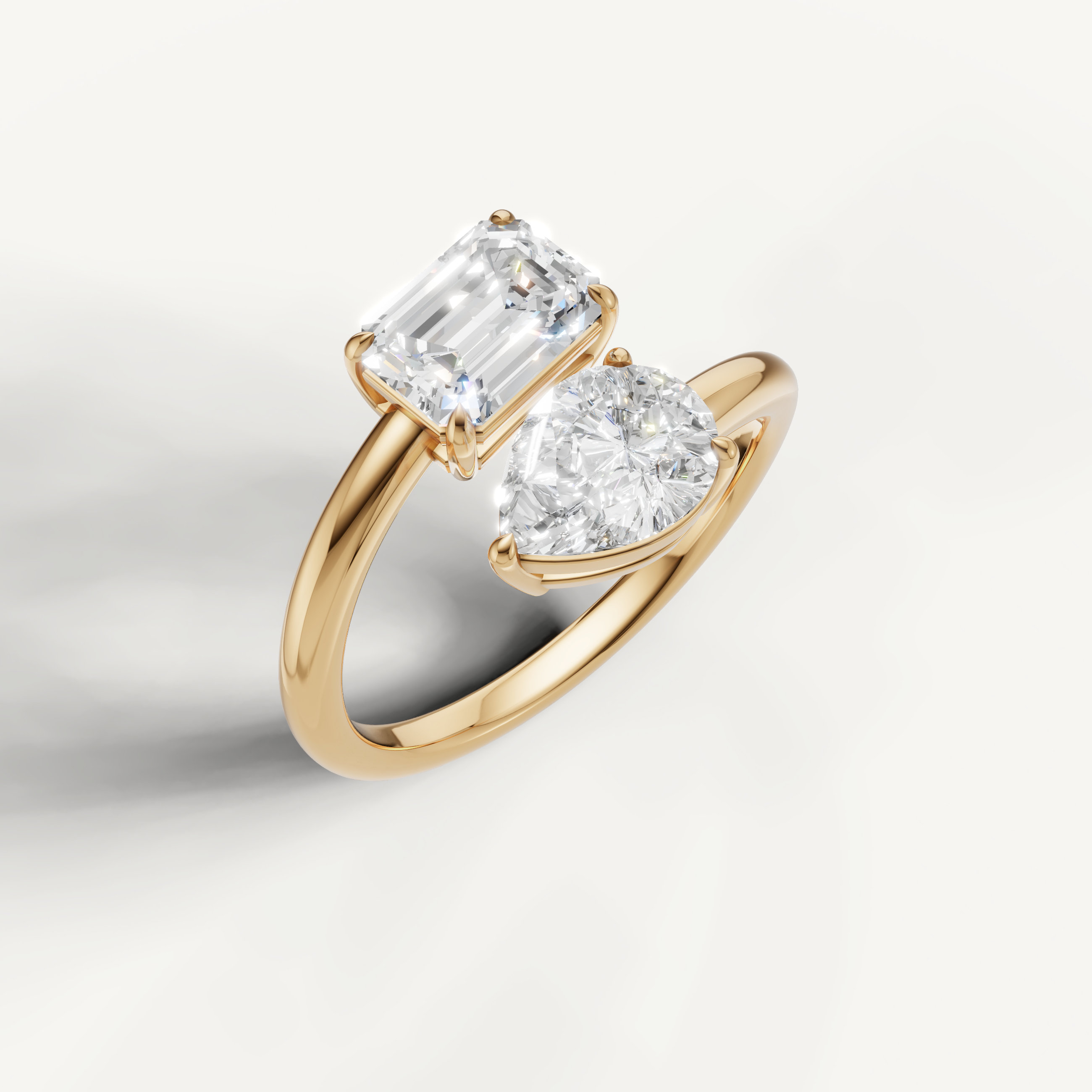 Luxury yellow gold open bypass diamond ring with pear and emerald cut stones by Raul Diamonds