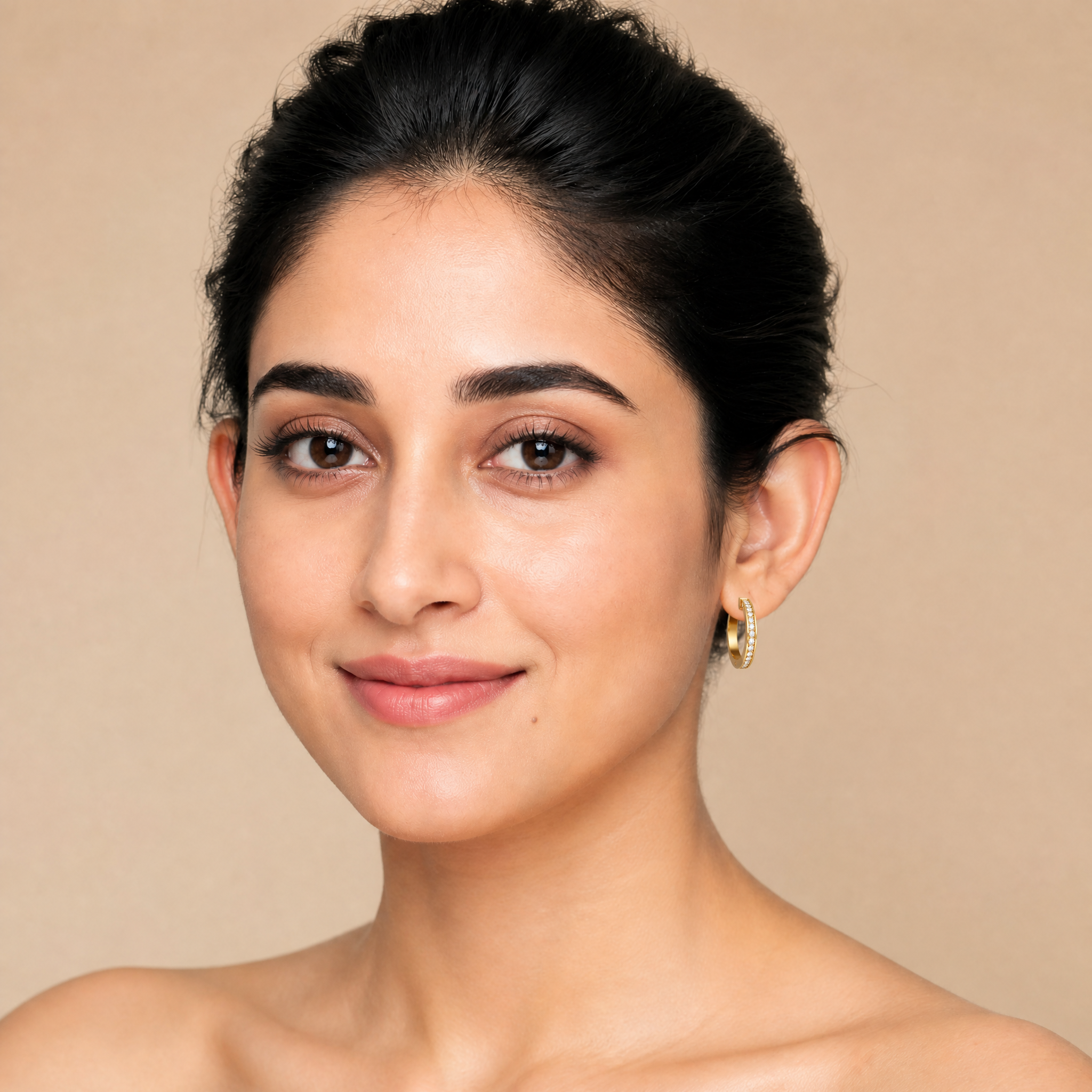 Elegant model wearing Raul Diamonds modern pave diamond hoop earrings with luxurious styling