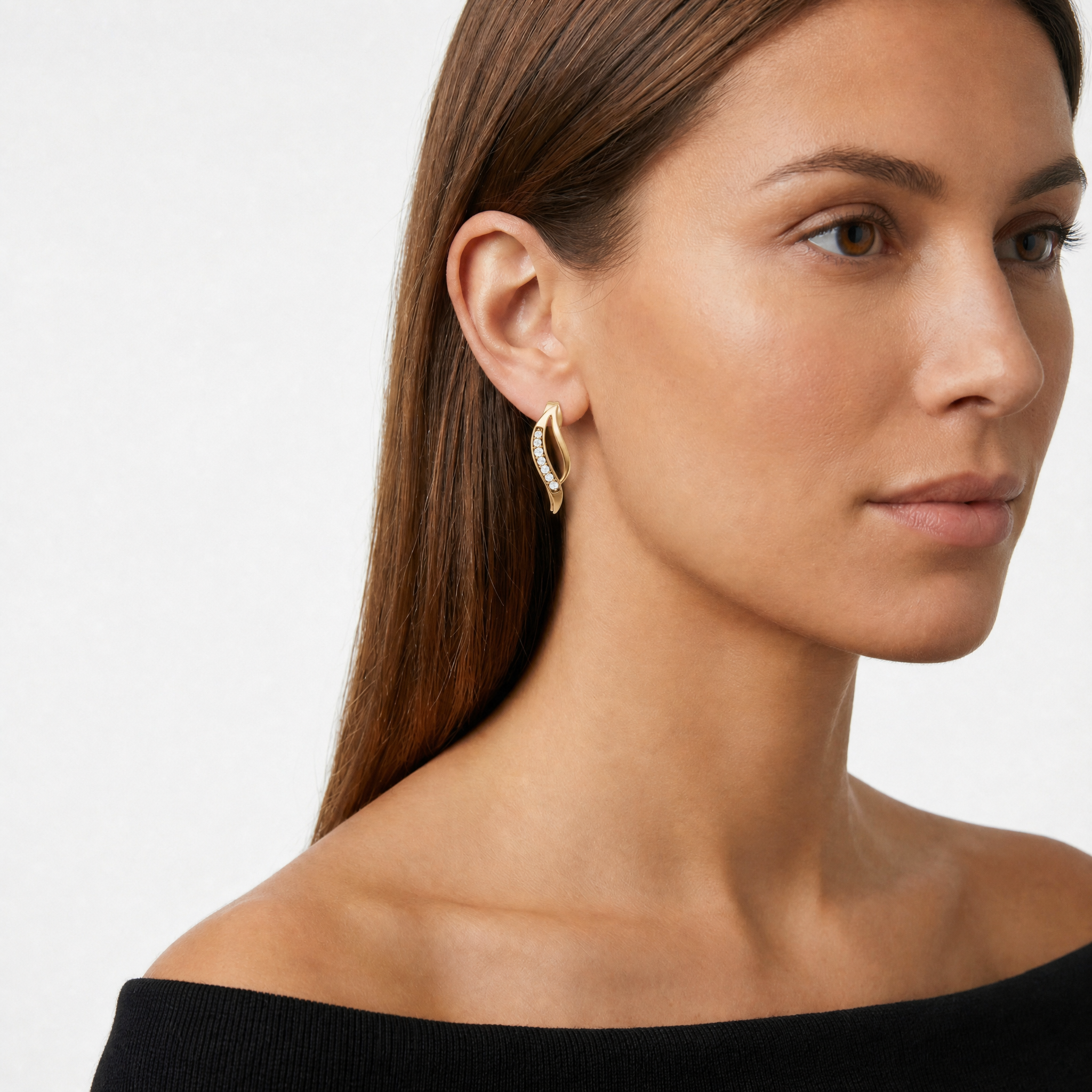Elegant model wearing Raul Diamonds curved pave diamond stud earrings with luxurious styling