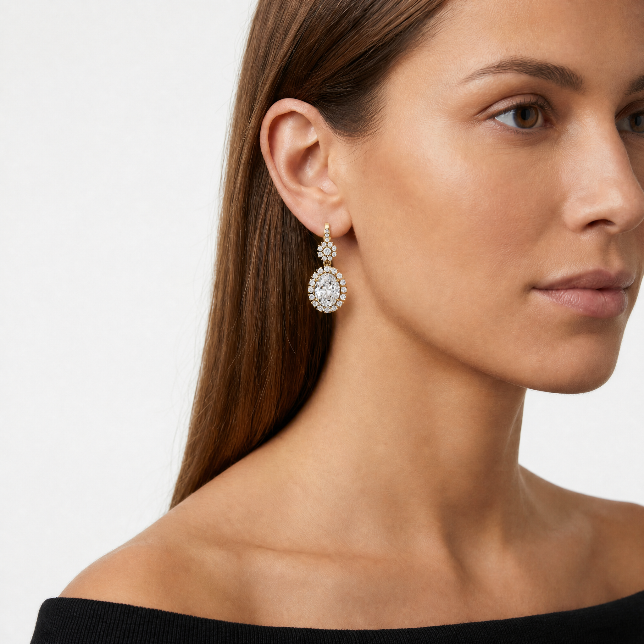 Elegant model wearing Raul Diamonds oval halo diamond drop earrings with luxurious sparkle