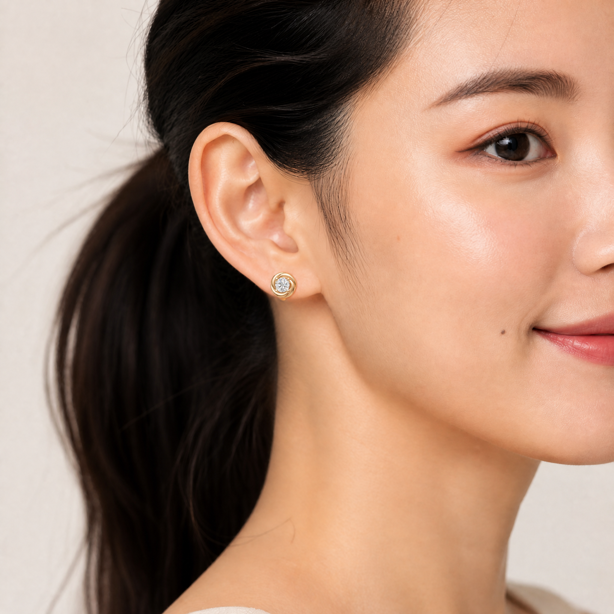 Elegant model wearing Raul Diamonds swirl halo diamond stud earrings with luxurious modern styling