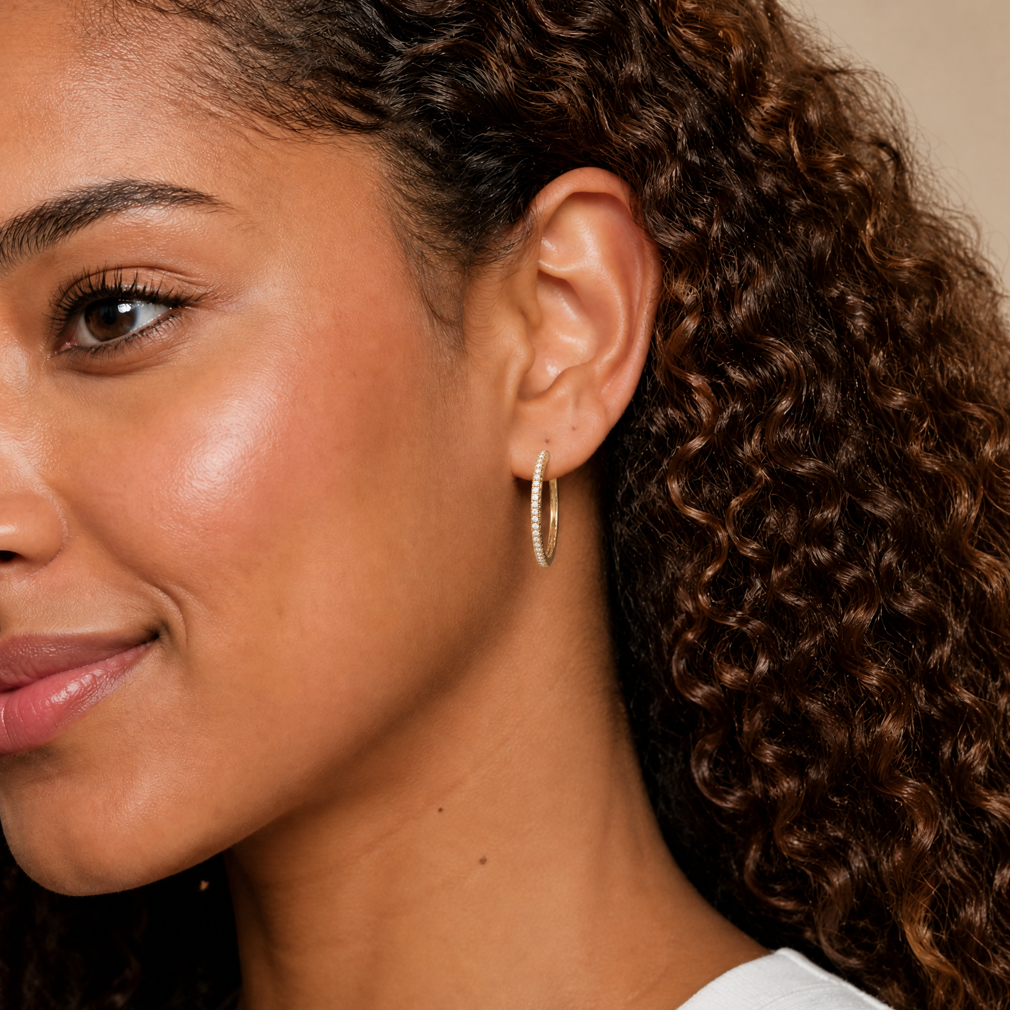 Elegant model wearing Raul Diamonds pave diamond hoop earrings with luxurious modern styling