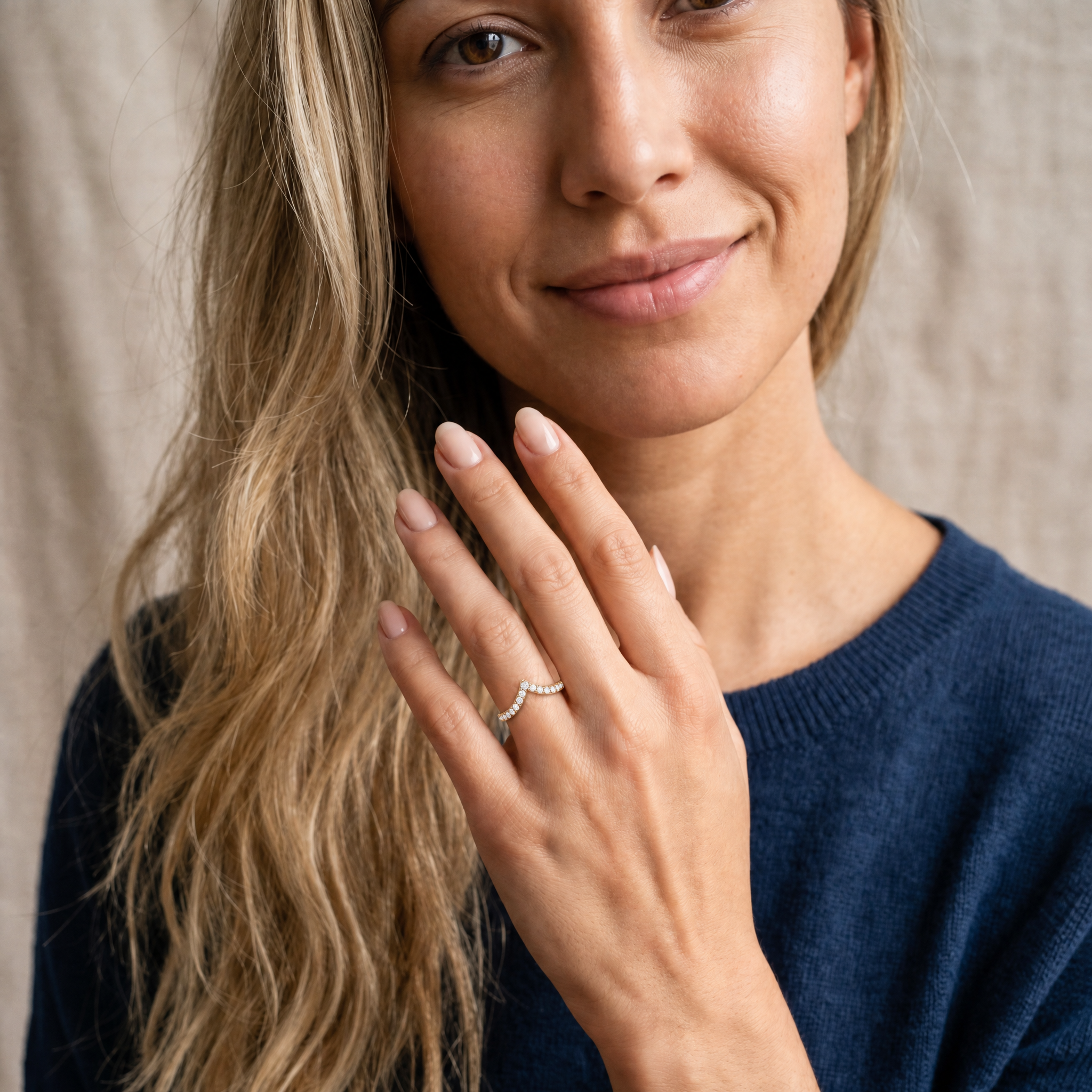 Model wearing Raul Diamonds yellow gold crown inspired curved diamond wedding band with round brilliant diamonds