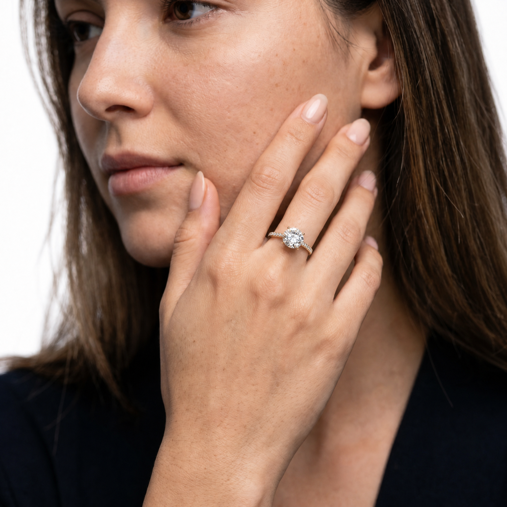 Model wearing Raul Diamonds round cut lab grown diamond engagement ring in yellow gold with a fine pavé diamond band and classic luxury bridal elegance