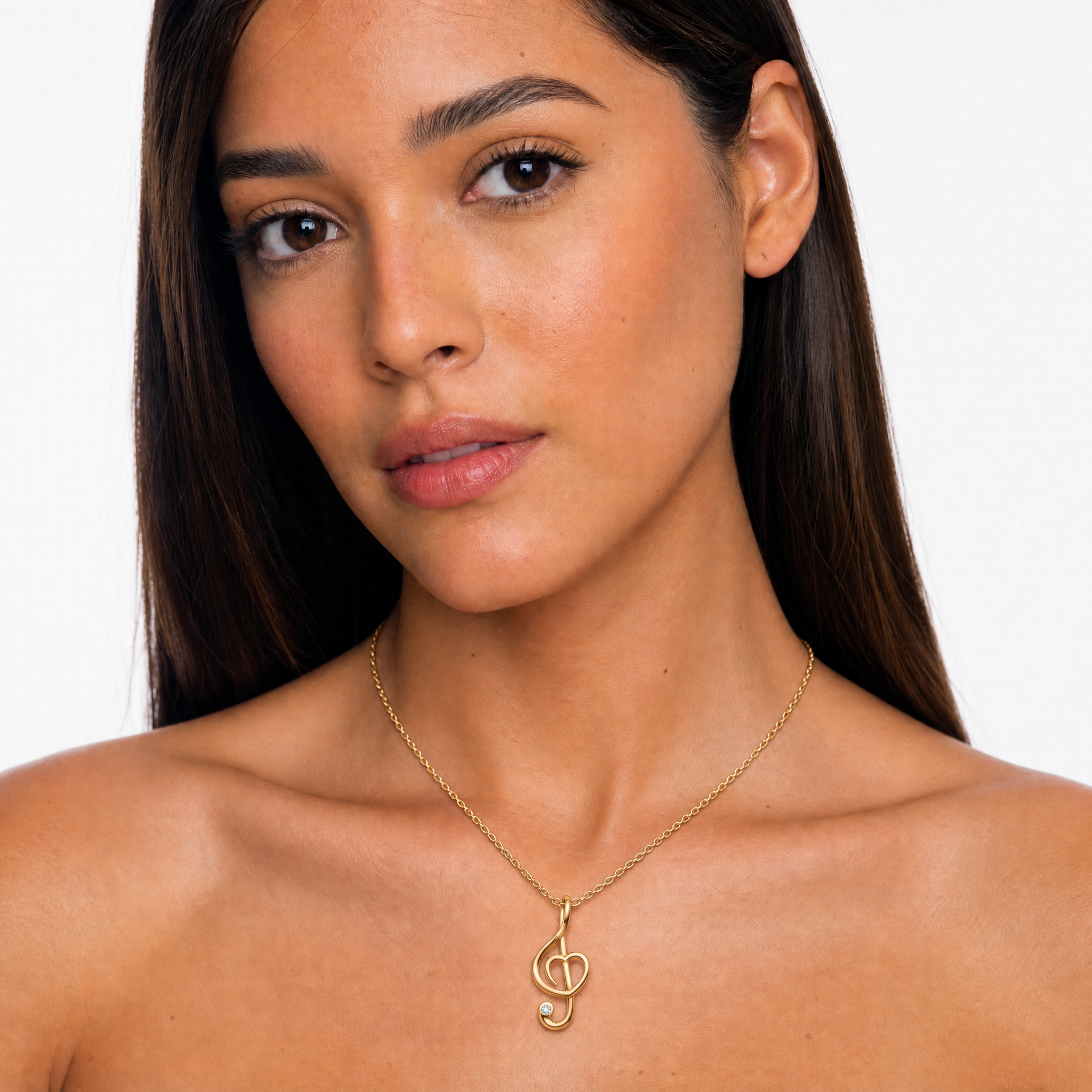 Model wearing Raul Diamonds yellow gold music note heart pendant necklace with round lab grown diamond accent and elegant chain design