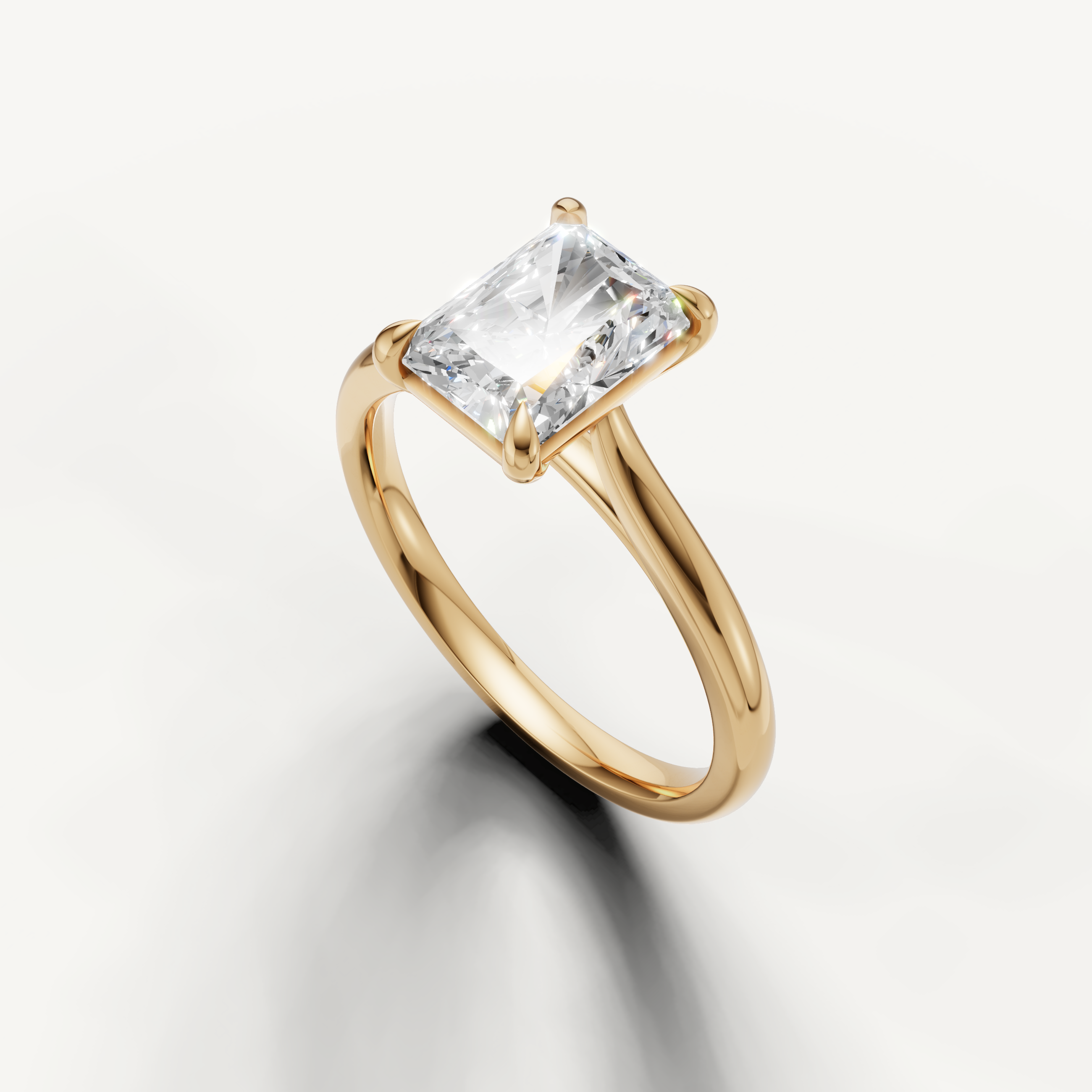 Elegant yellow gold radiant engagement ring with elongated diamond centerpiece by Raul Diamonds