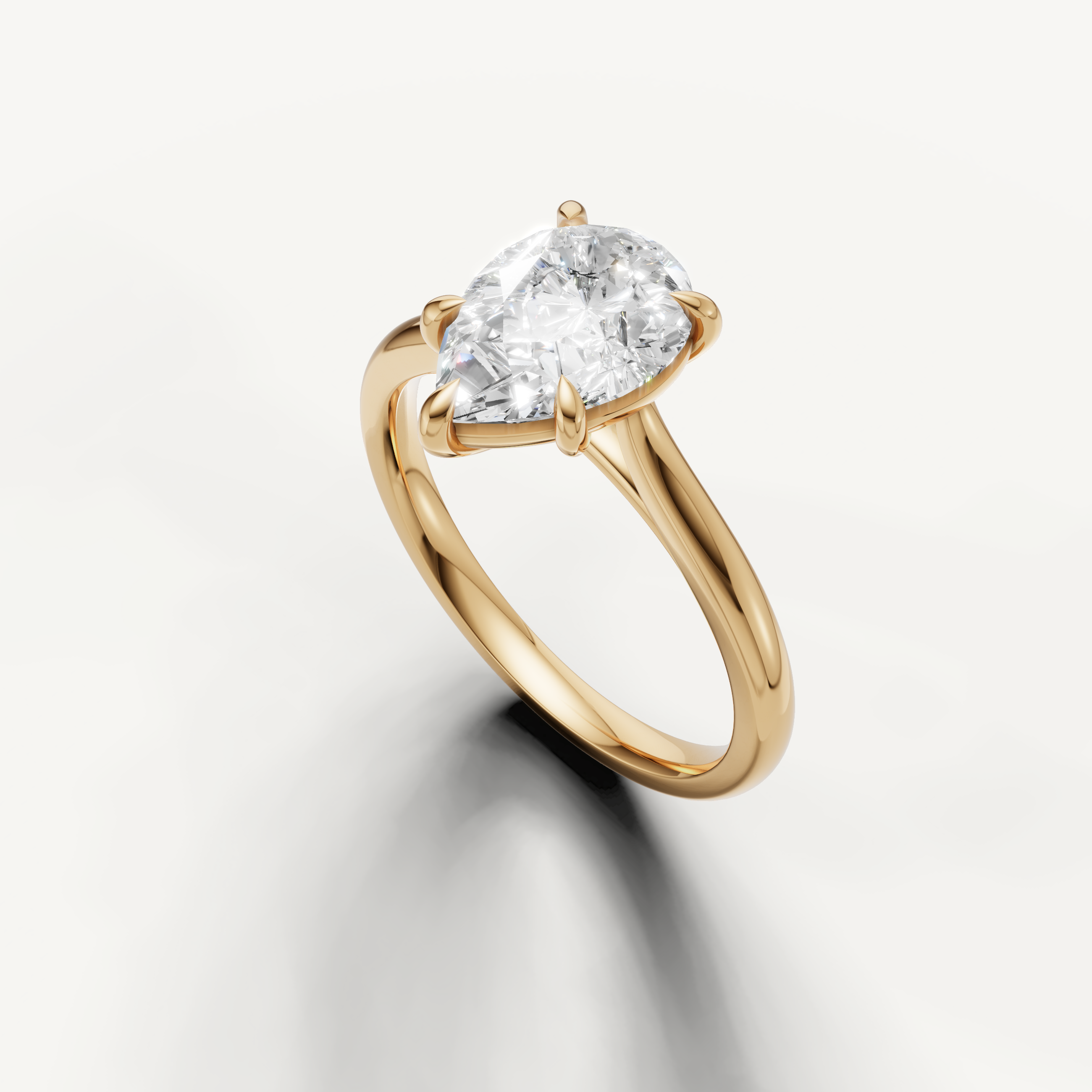 Elegant yellow gold pear engagement ring featuring brilliant teardrop diamond by Raul Diamonds