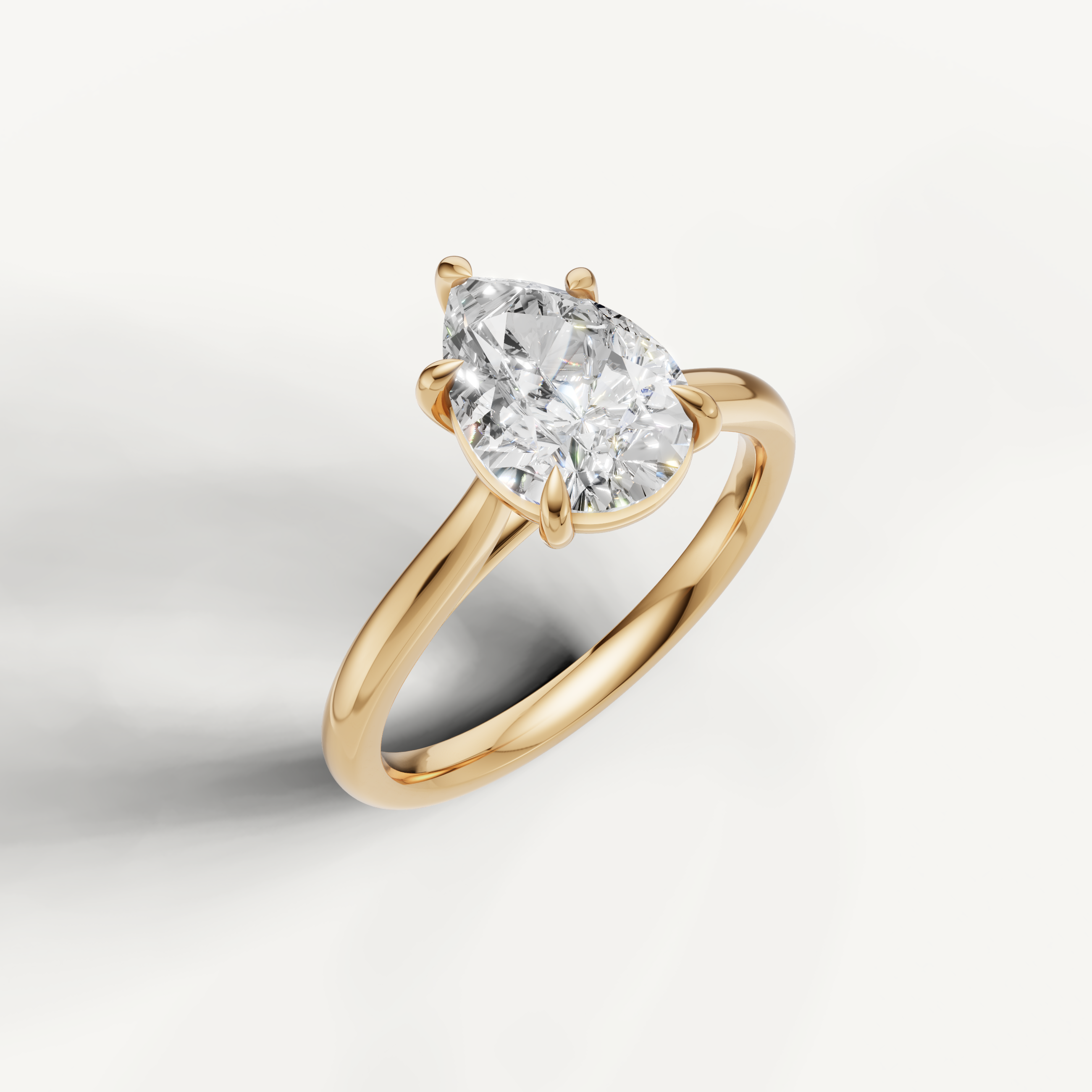 Luxury pear shaped diamond ring in yellow gold by Raul Diamonds with timeless bridal design