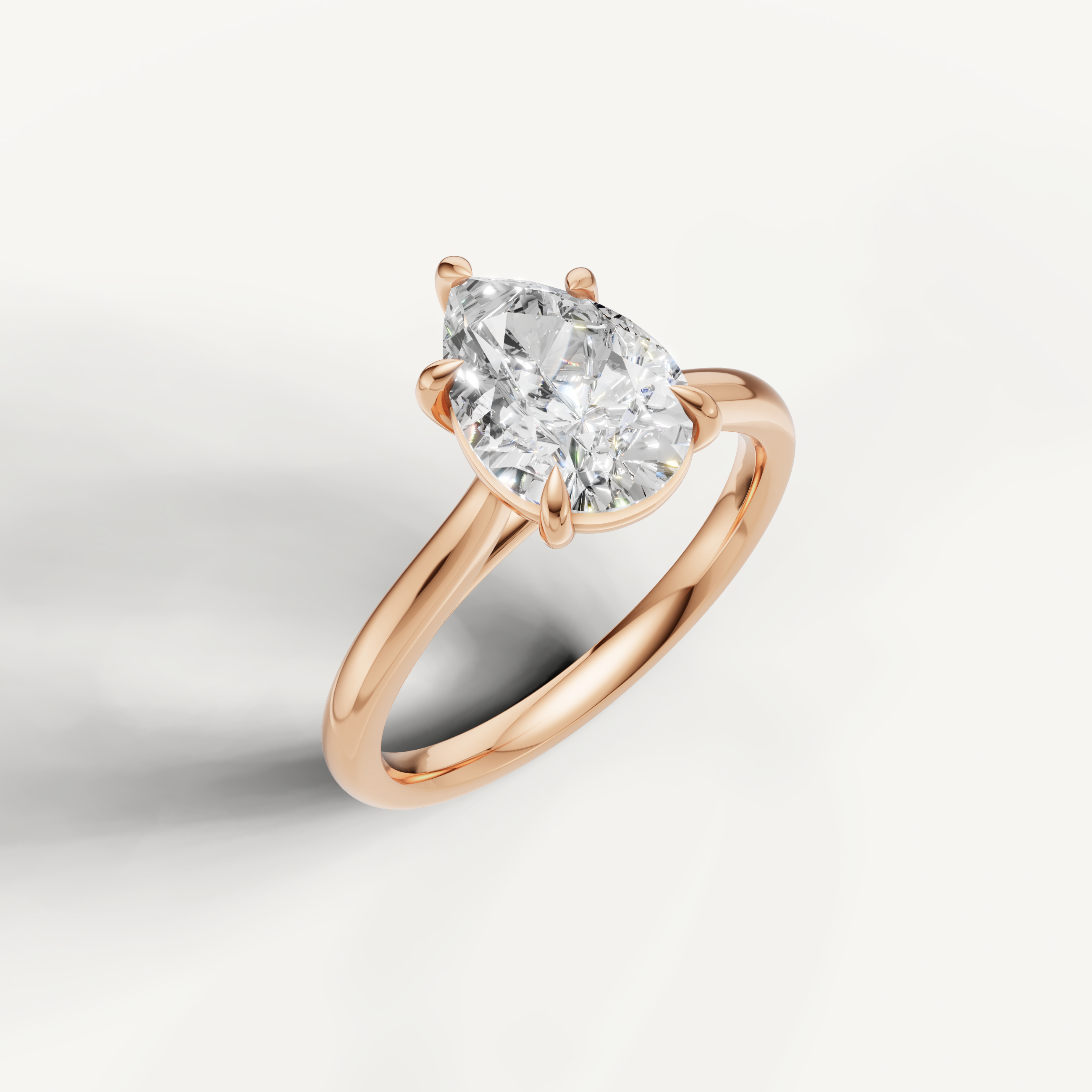 Rose gold pear shaped diamond ring by Raul Diamonds with sleek modern band