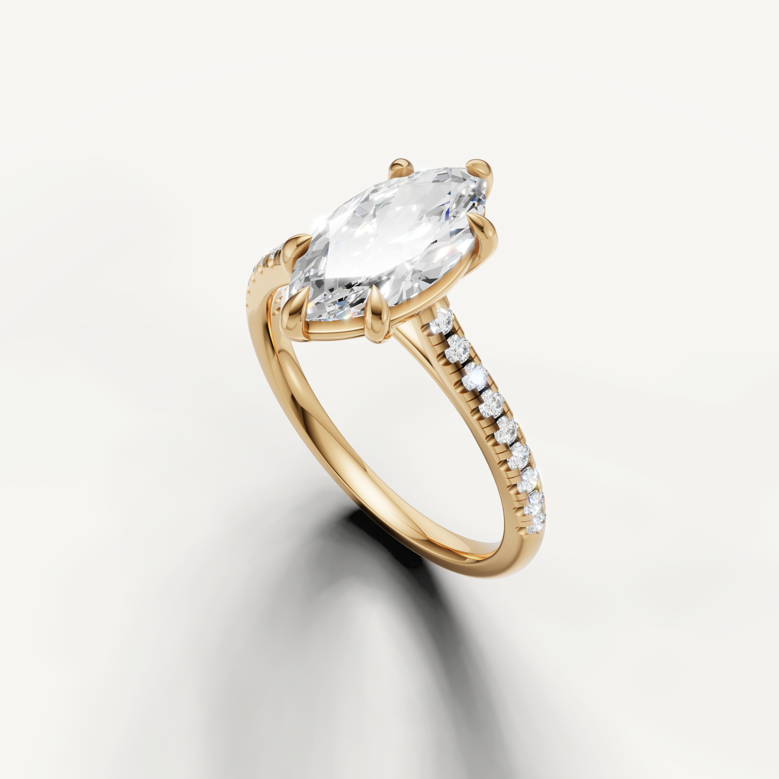 Elegant yellow gold marquise cut solitaire ring with pavé band by Raul Diamonds