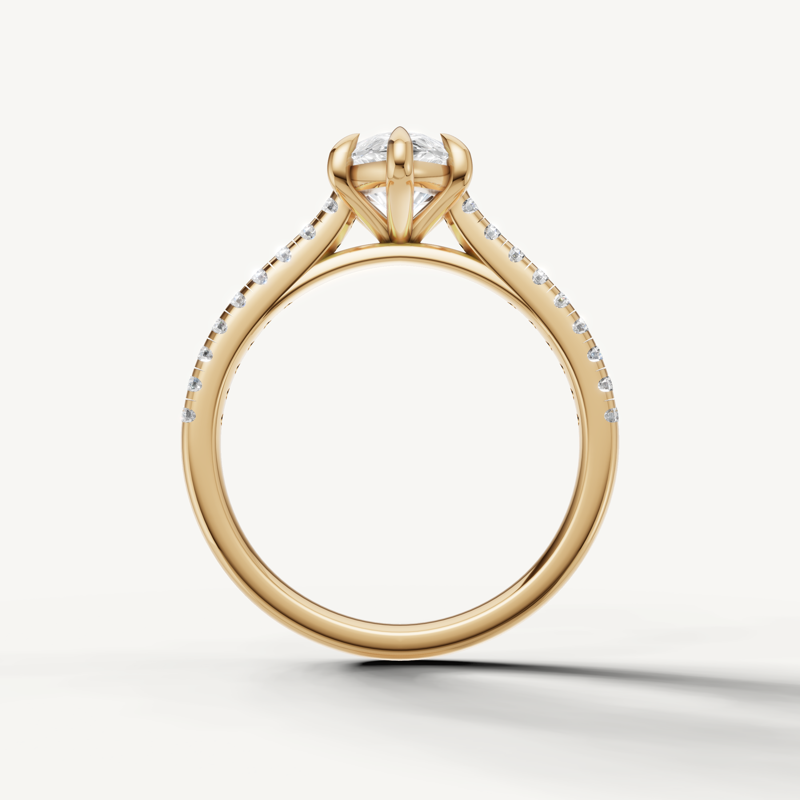 Handmade yellow gold pear cut diamond ring with sparkling pavé band from Raul Diamonds