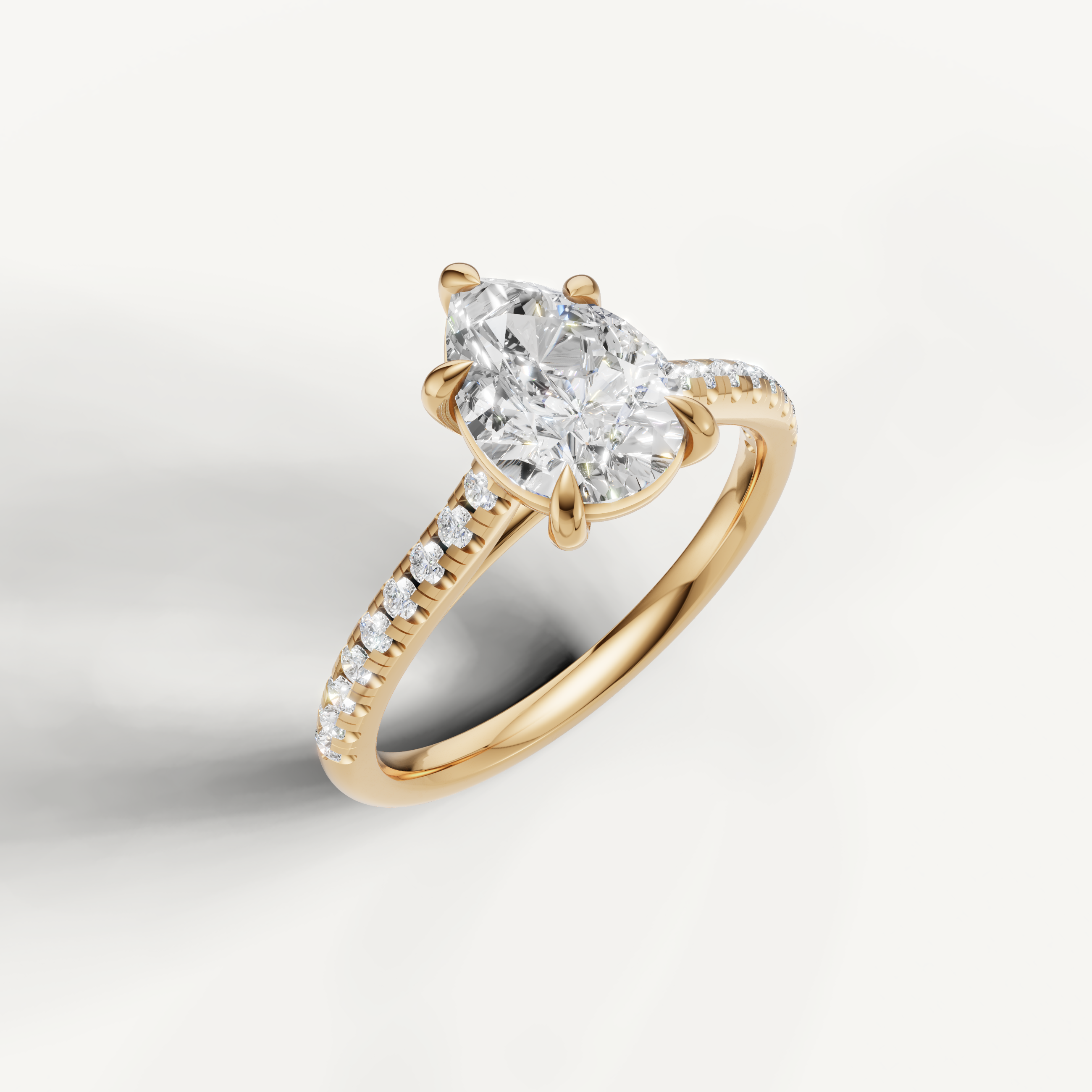 Luxury pear shaped diamond ring in polished yellow gold by Raul Diamonds with elegant pavé setting