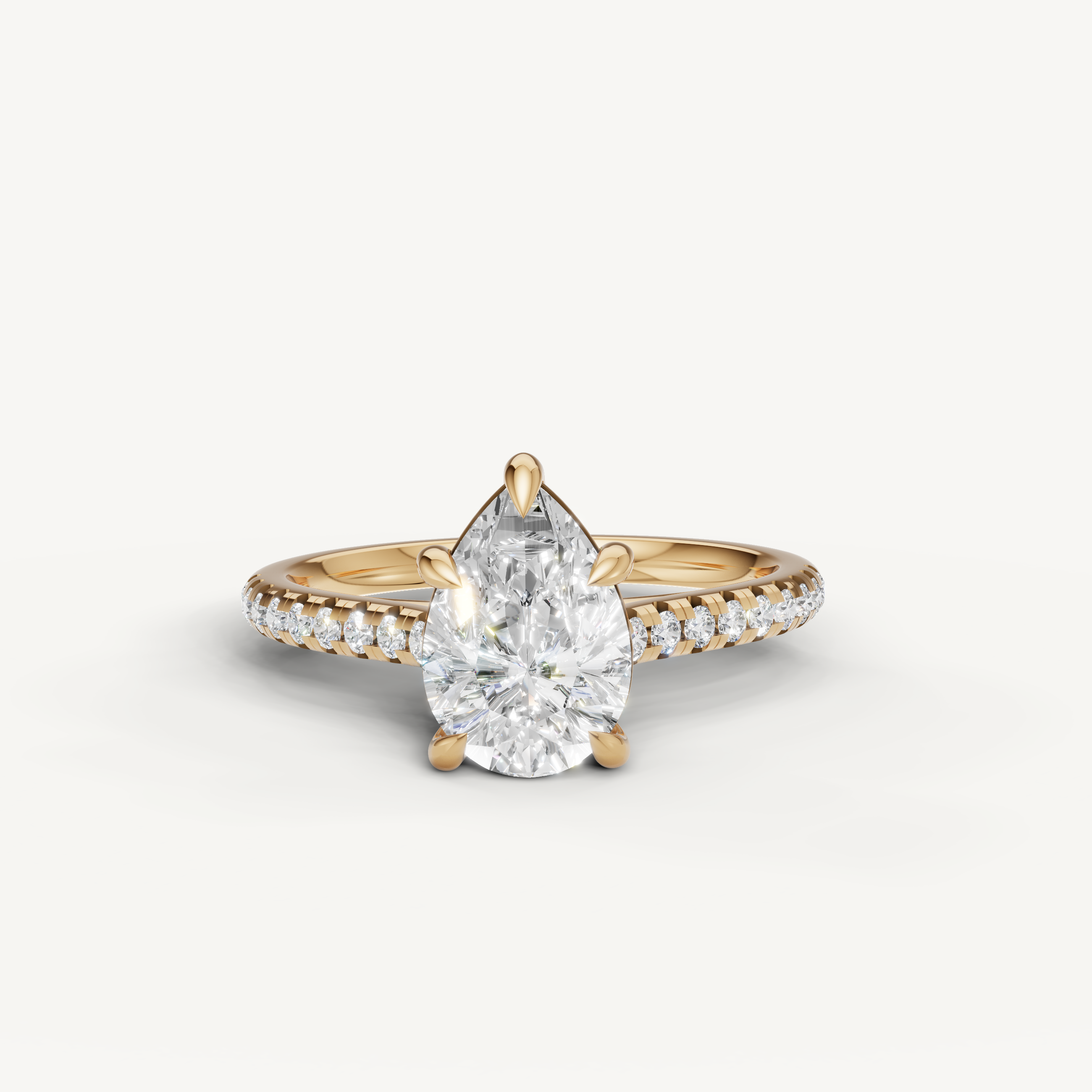 Raul Diamonds pear cut engagement ring in yellow gold with pavé diamond band and solitaire pear diamond
