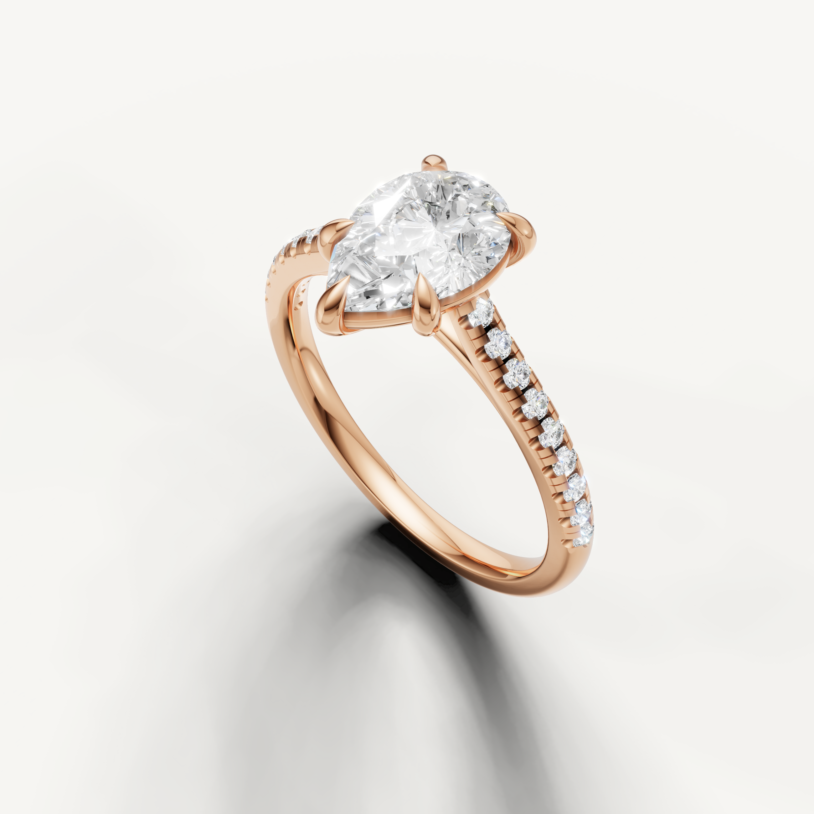 Rose gold pear diamond ring featuring elegant solitaire center stone and diamond accented band