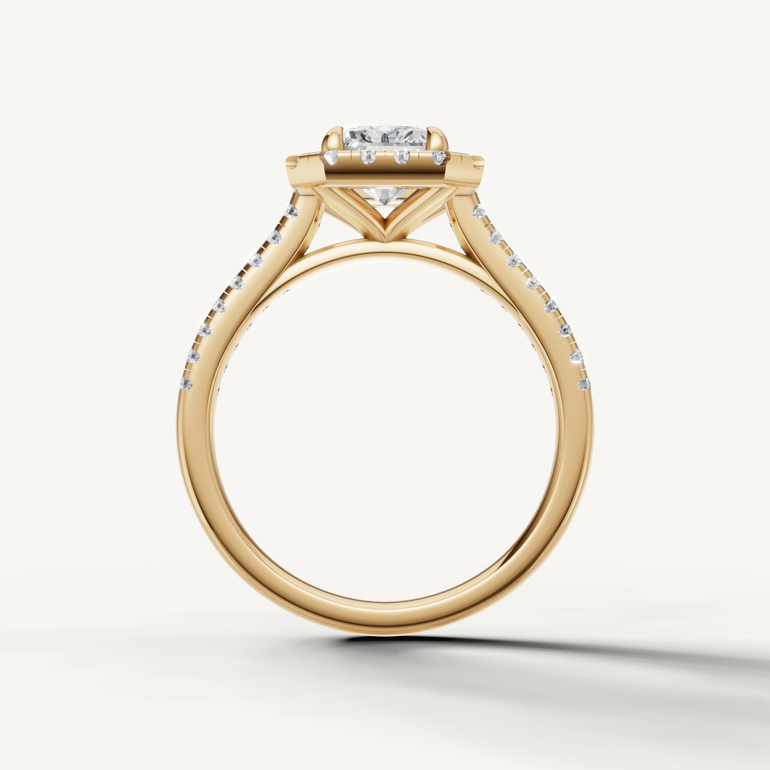 Handmade radiant cut halo diamond ring in yellow gold with elegant pavé setting from Raul Diamonds