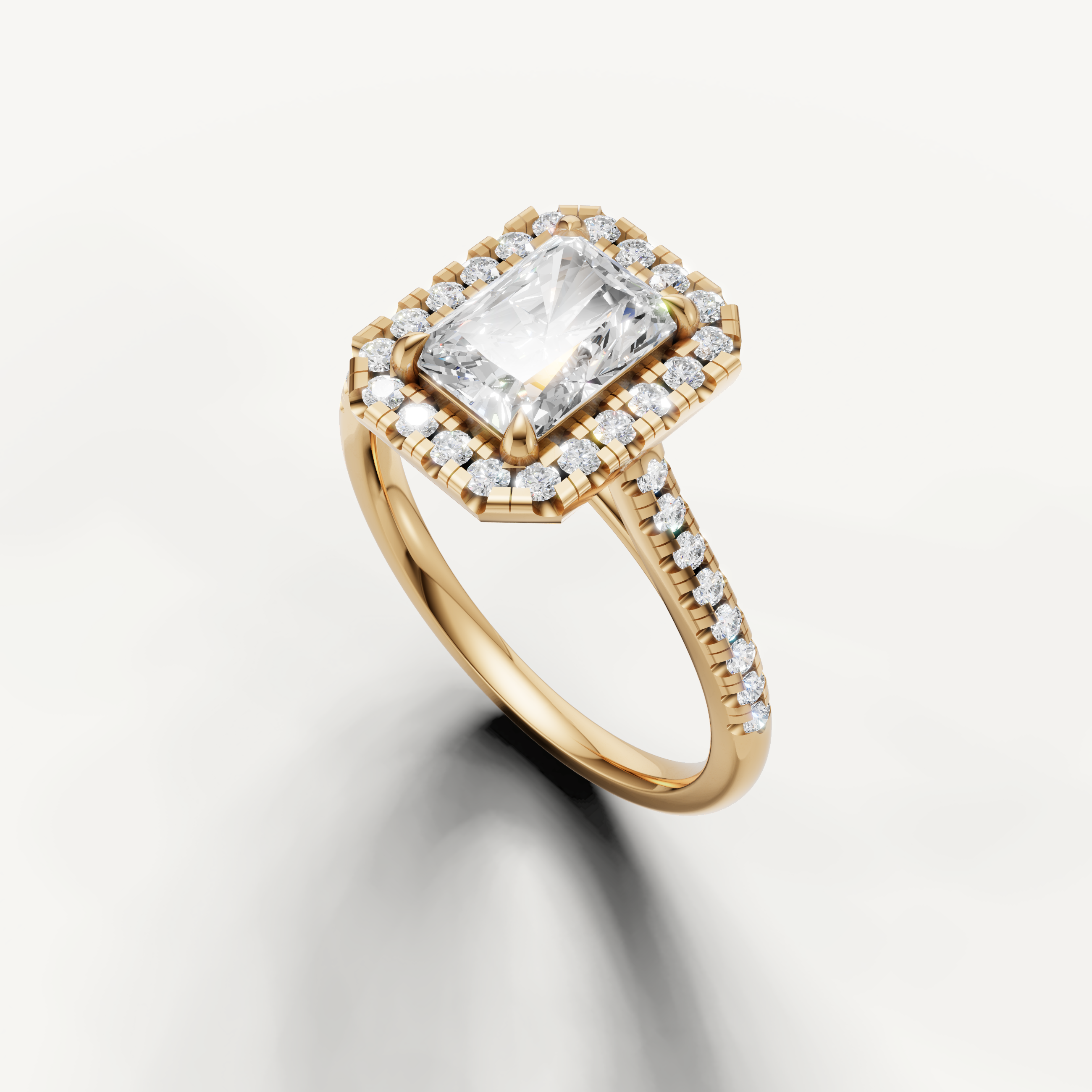 Yellow gold radiant cut engagement ring featuring diamond halo and pavé band by Raul Diamonds