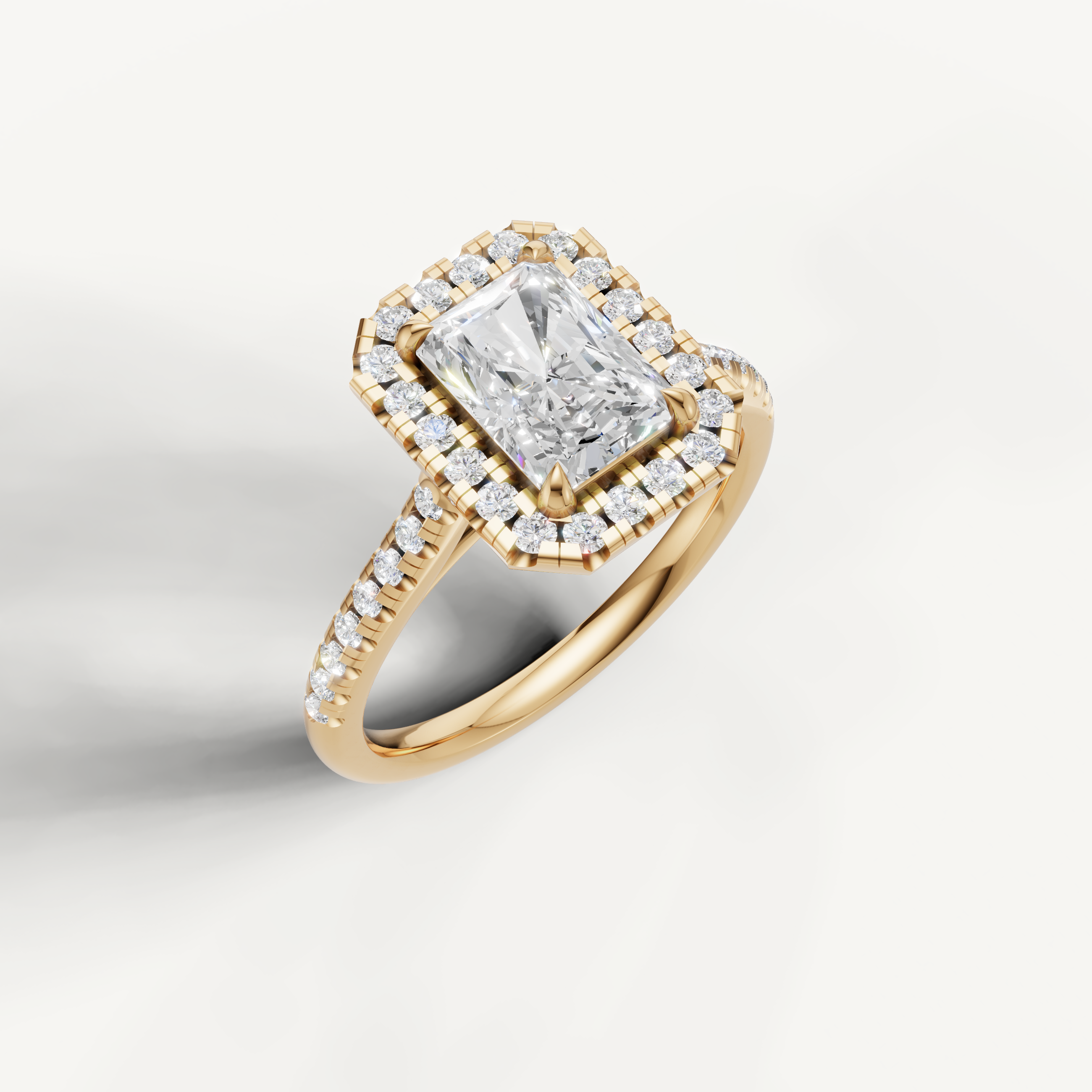 Luxury radiant diamond halo ring in polished yellow gold by Raul Diamonds with sparkling pavé details