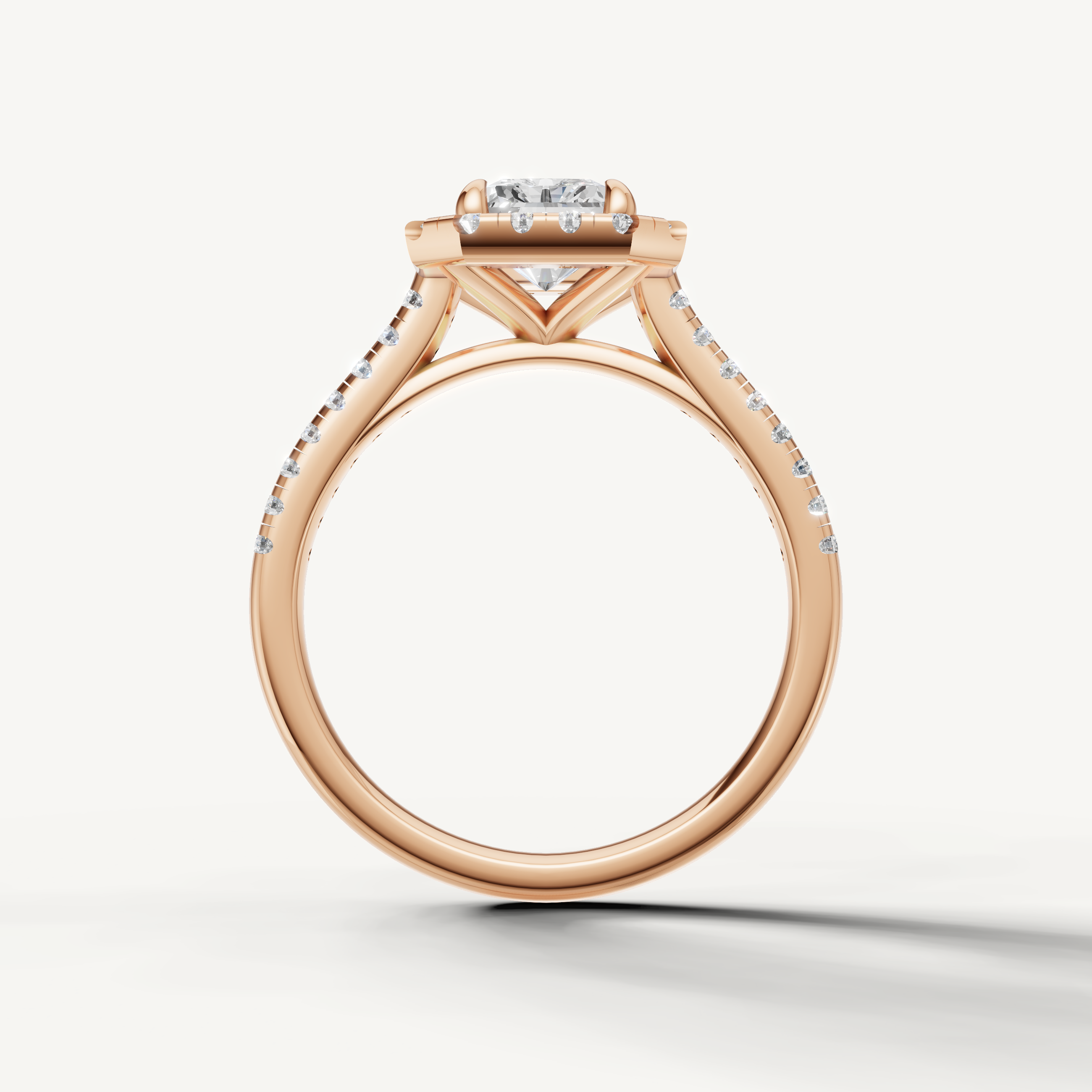 Luxury radiant halo diamond ring in rose gold by Raul Diamonds with elegant solitaire center stone