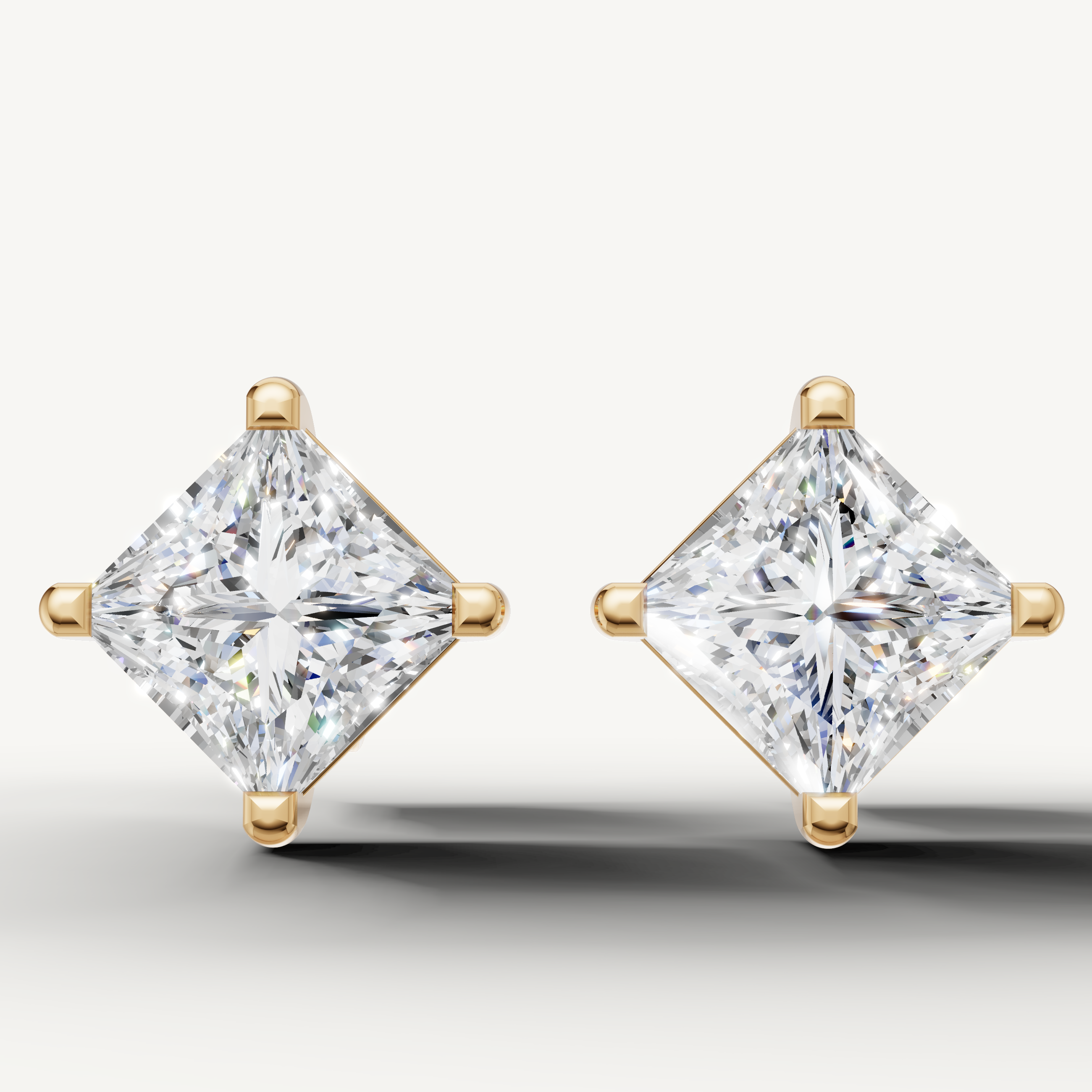 Princess cut lab grown diamond stud earrings in 14K yellow gold by Raul Diamonds