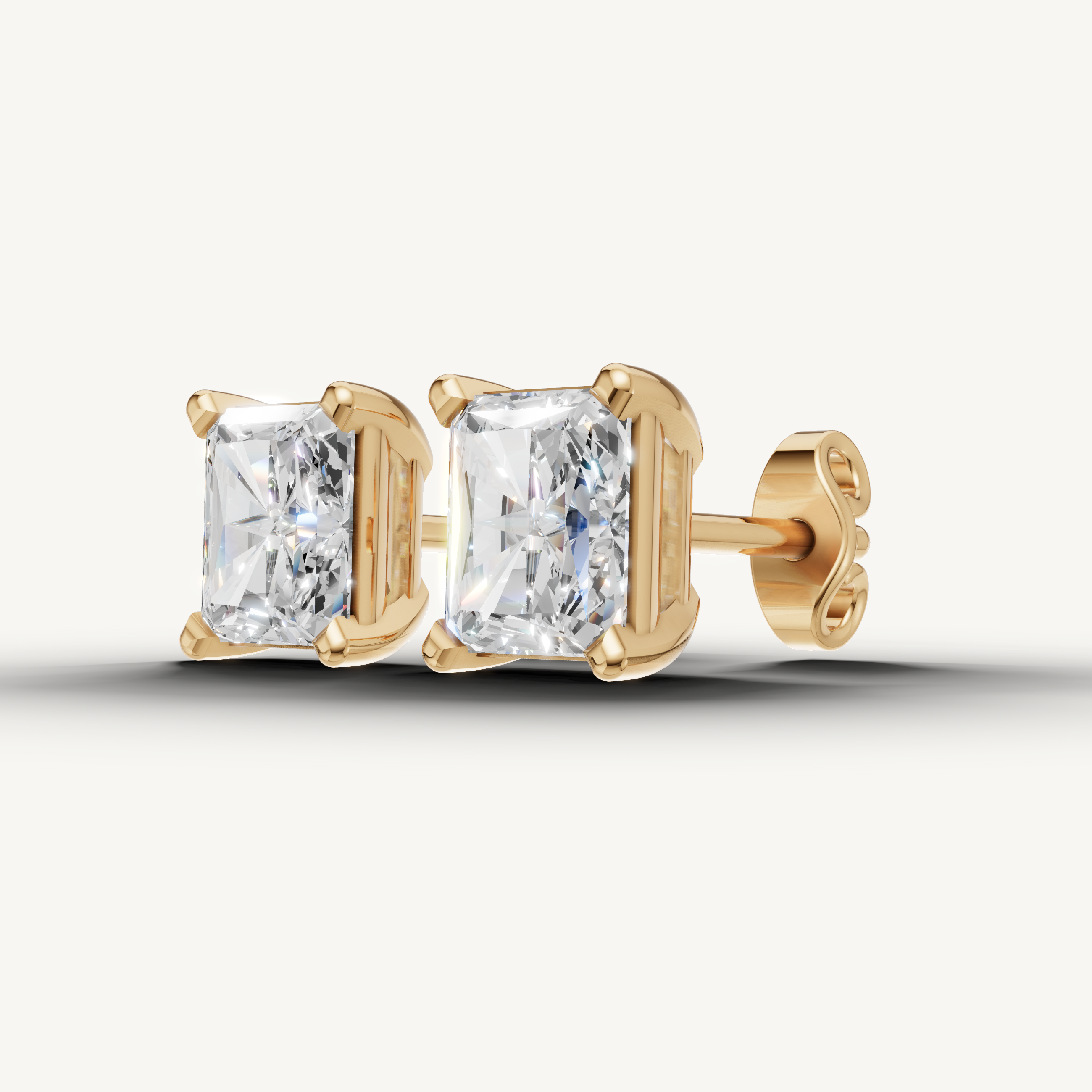 Elegant yellow gold radiant diamond earrings with modern sophistication by Raul Diamonds