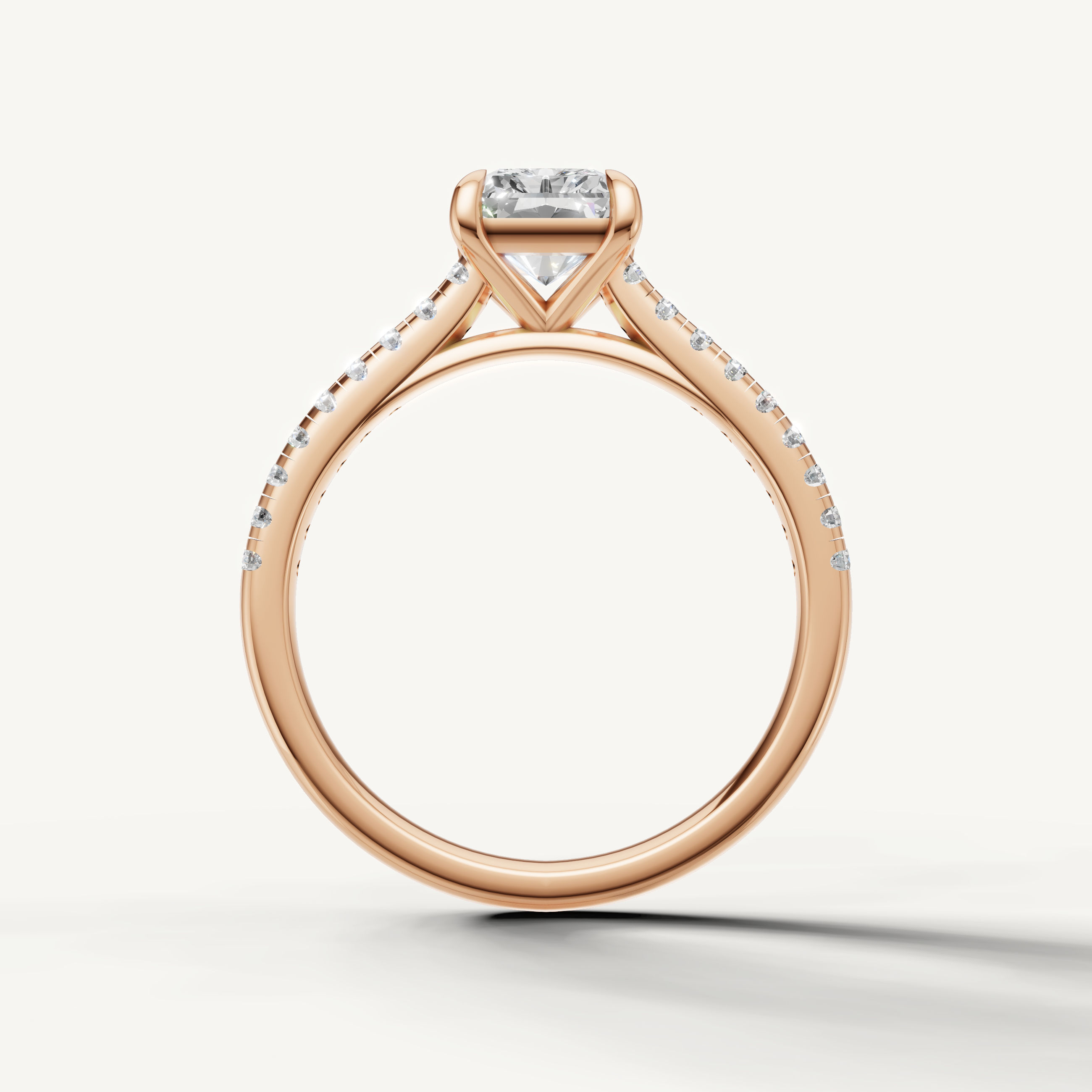 Modern rose gold radiant solitaire ring with pavé diamonds by Raul Diamonds