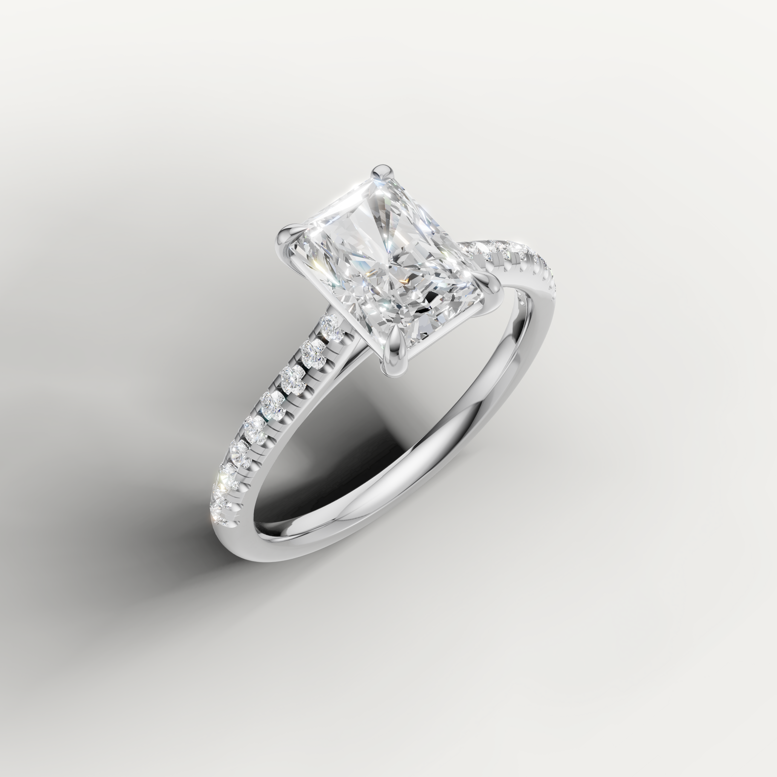 White gold radiant diamond ring by Raul Diamonds with shimmering side stones