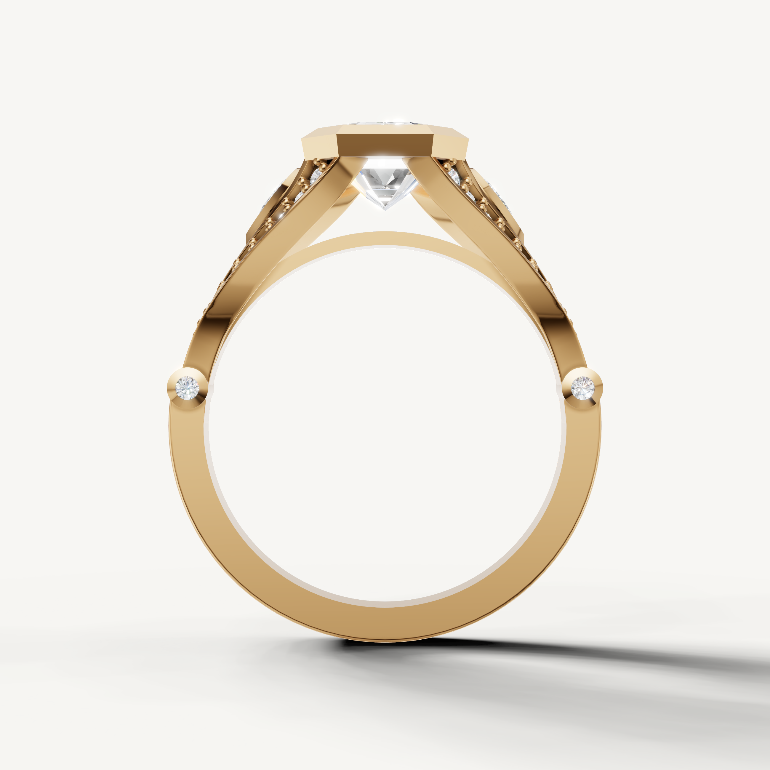 Close-up of Seo emerald cut bezel set diamond ring in yellow gold by Raul Diamonds.