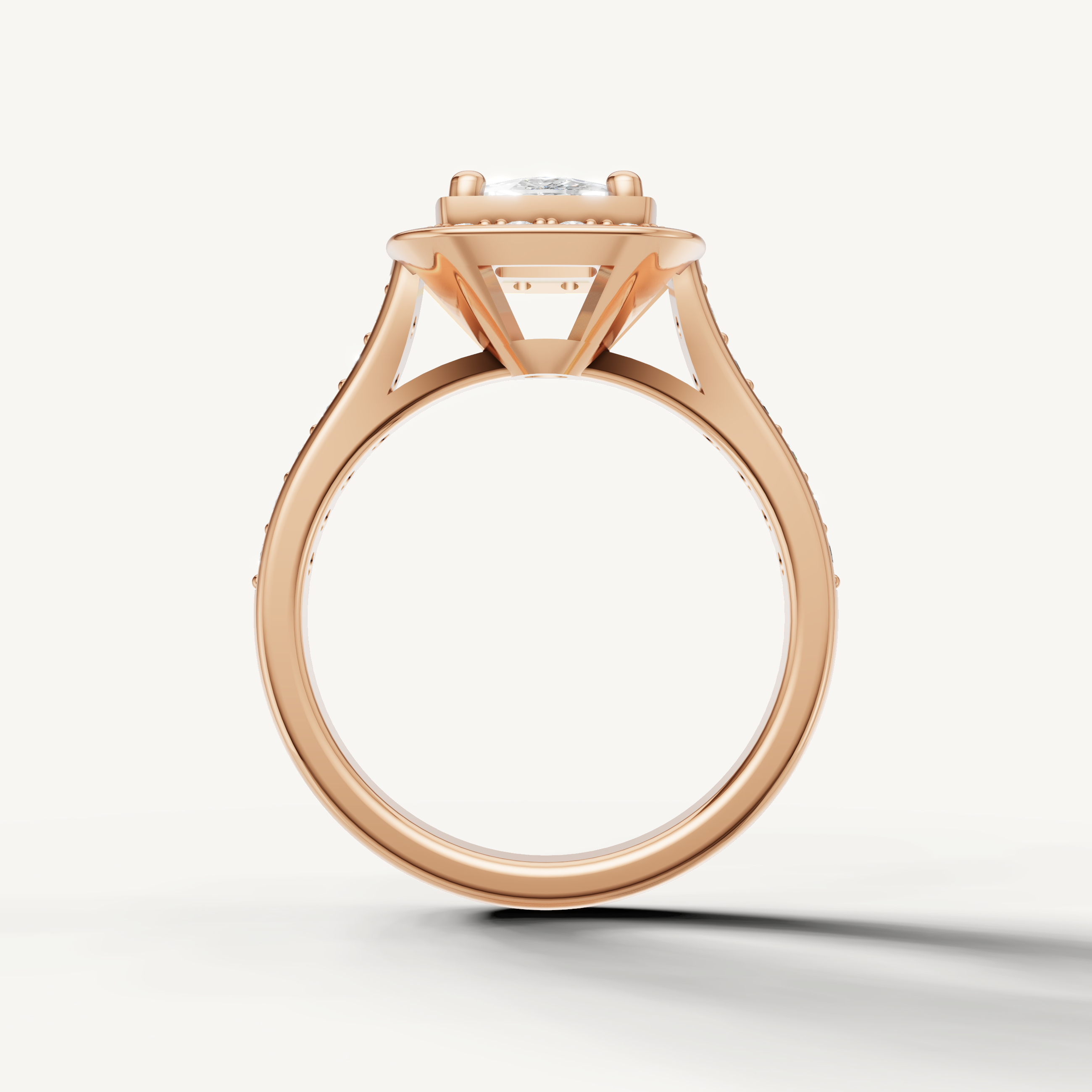 Brilliant round center stone on Seo rose gold halo engagement ring by Raul Diamonds.
